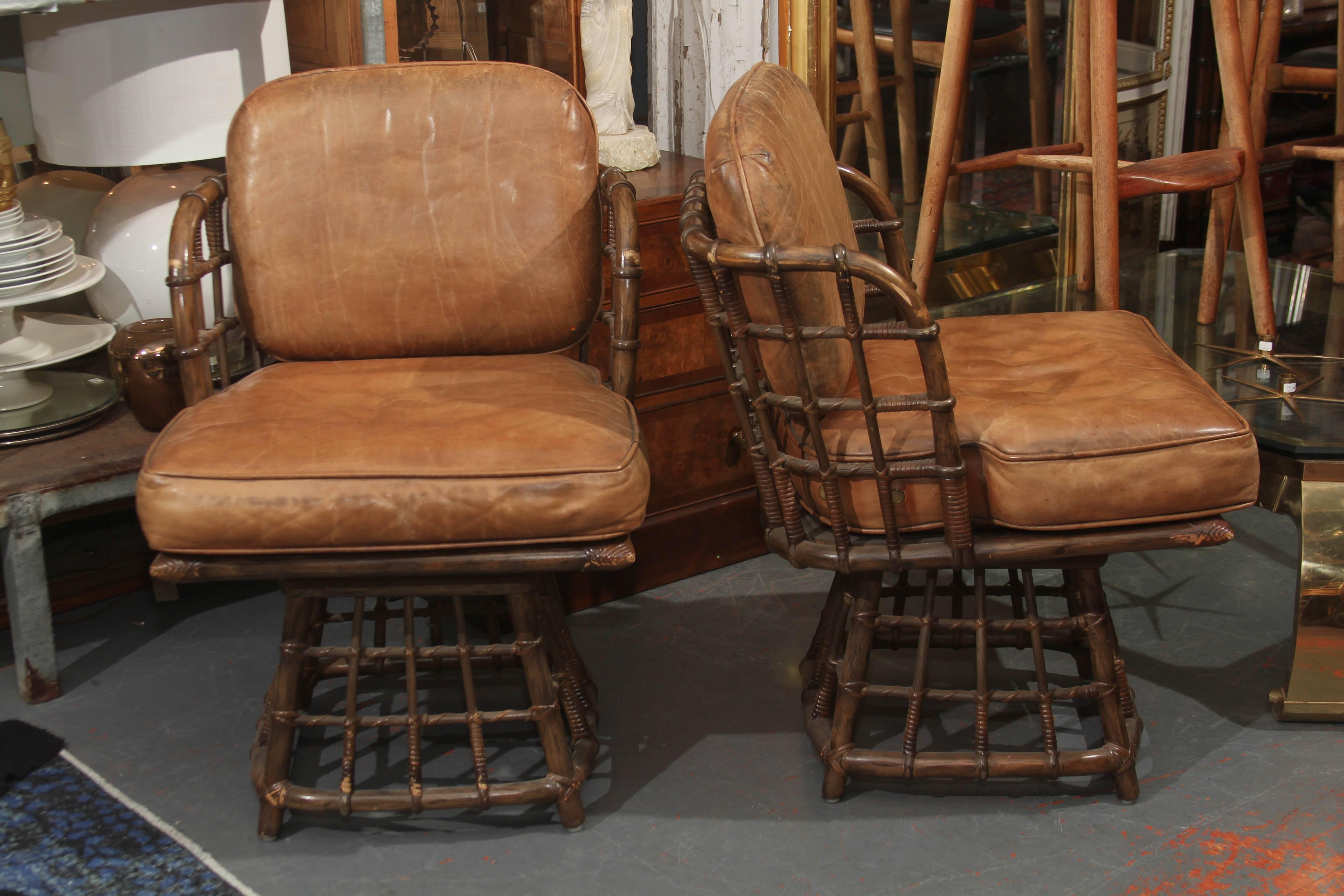 Pair of Mid-Century leather swivel side chairs by Maguire. Leather seat and back, great original condition.