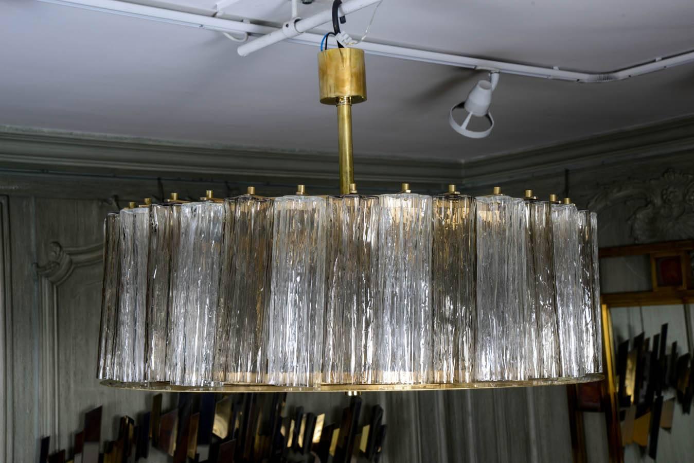 Pair of chandeliers in Murano white and smoked glass, brass structure, six bulbs per chandelier.