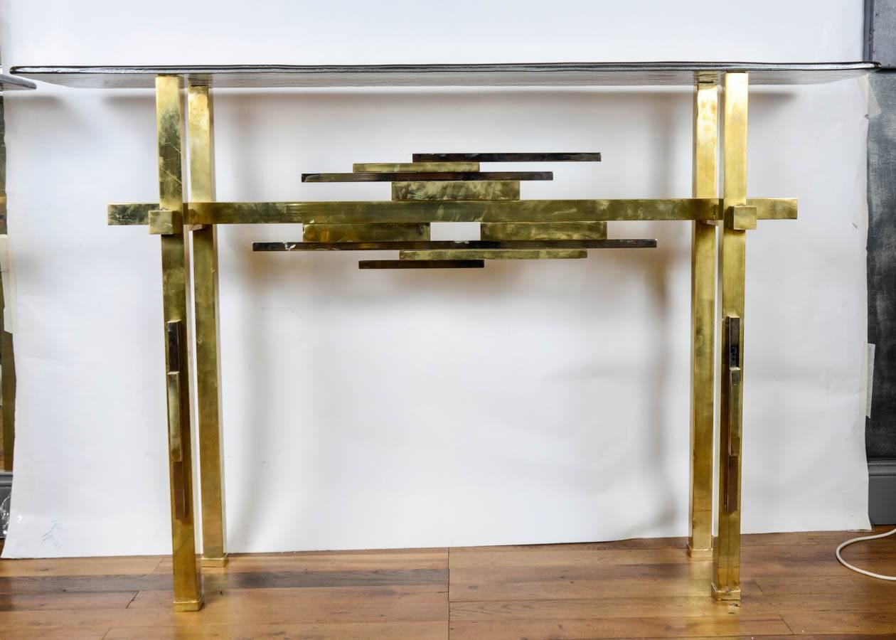 Pair of consoles with brass basement, top in blowed glass.