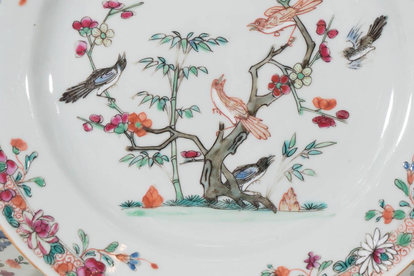 A set of ten Famille Rose, mid-18th century, Chinese dishes painted in rich enamels showing a lovely garden scene with three pairs of songbirds amidst bamboo and flowering trees. In Chinese tradition this imagery symbolizes youth, beauty, and good
