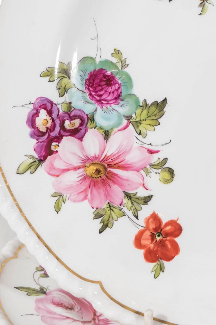 A lovely set of 19th century Royal Crown Derby dishes each with beautiful hand-painted flowers in vibrant colors. With a gilt lined border and slightly lobed and gadrooned edge. The plate has a diameter of 10.25" which is a wonderful large size