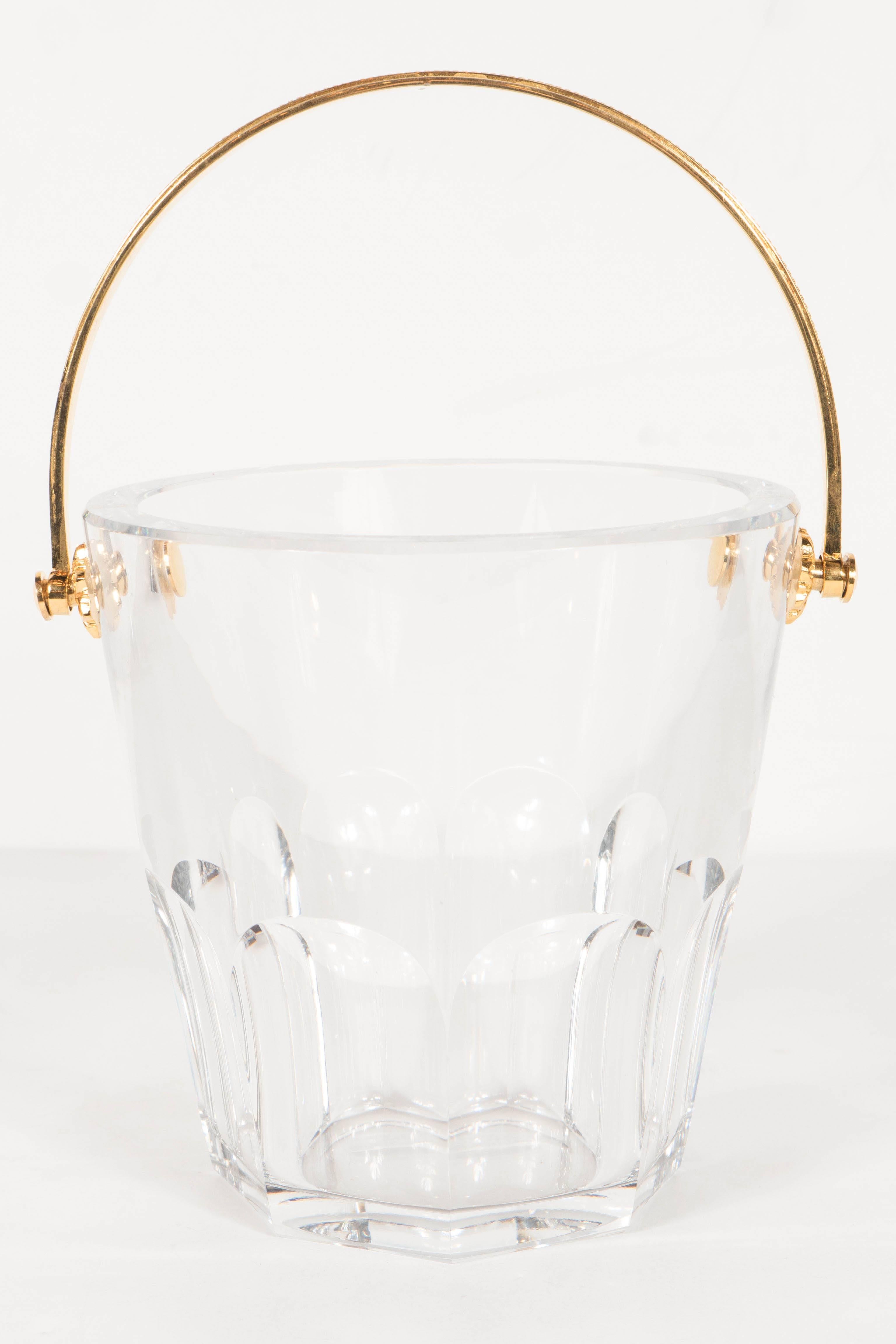 Ultra-luxe crystal ice pail with 24-karat gilt handle by Baccarat. Needed and stylized floral detailing and gold-plated fittings support an ornamented handle. An octagonal base and round, bevelled top give the crystal pail an elegant solidity.