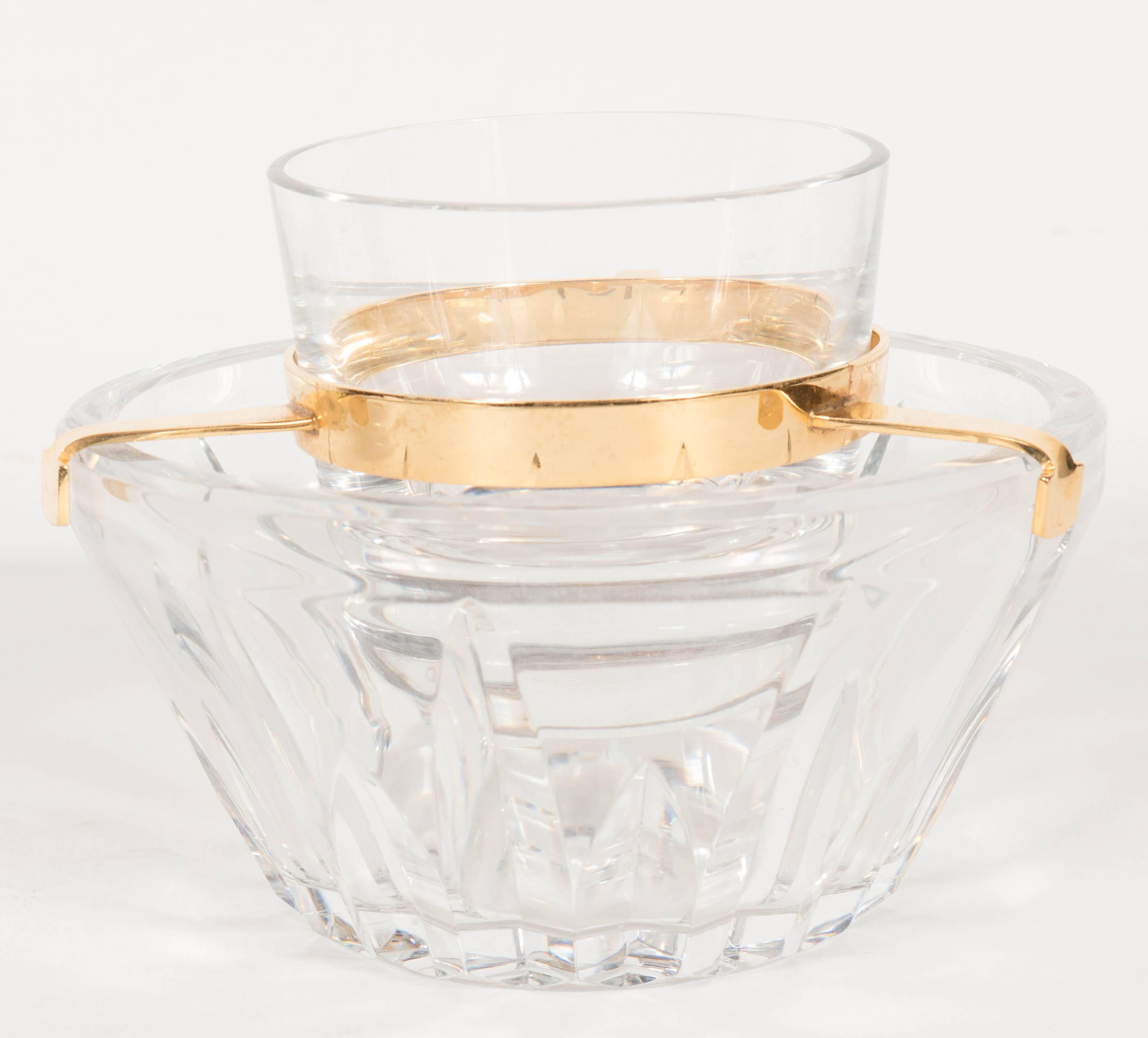 A truly exquisite hand-cut crystal caviar dish set comprising a rounded caviar dish, 24-Karat gold-plated three-pronged holder and etched crystal cooling bowl. A quintessential piece for any Baccarat collection. It does not get any more elegant than