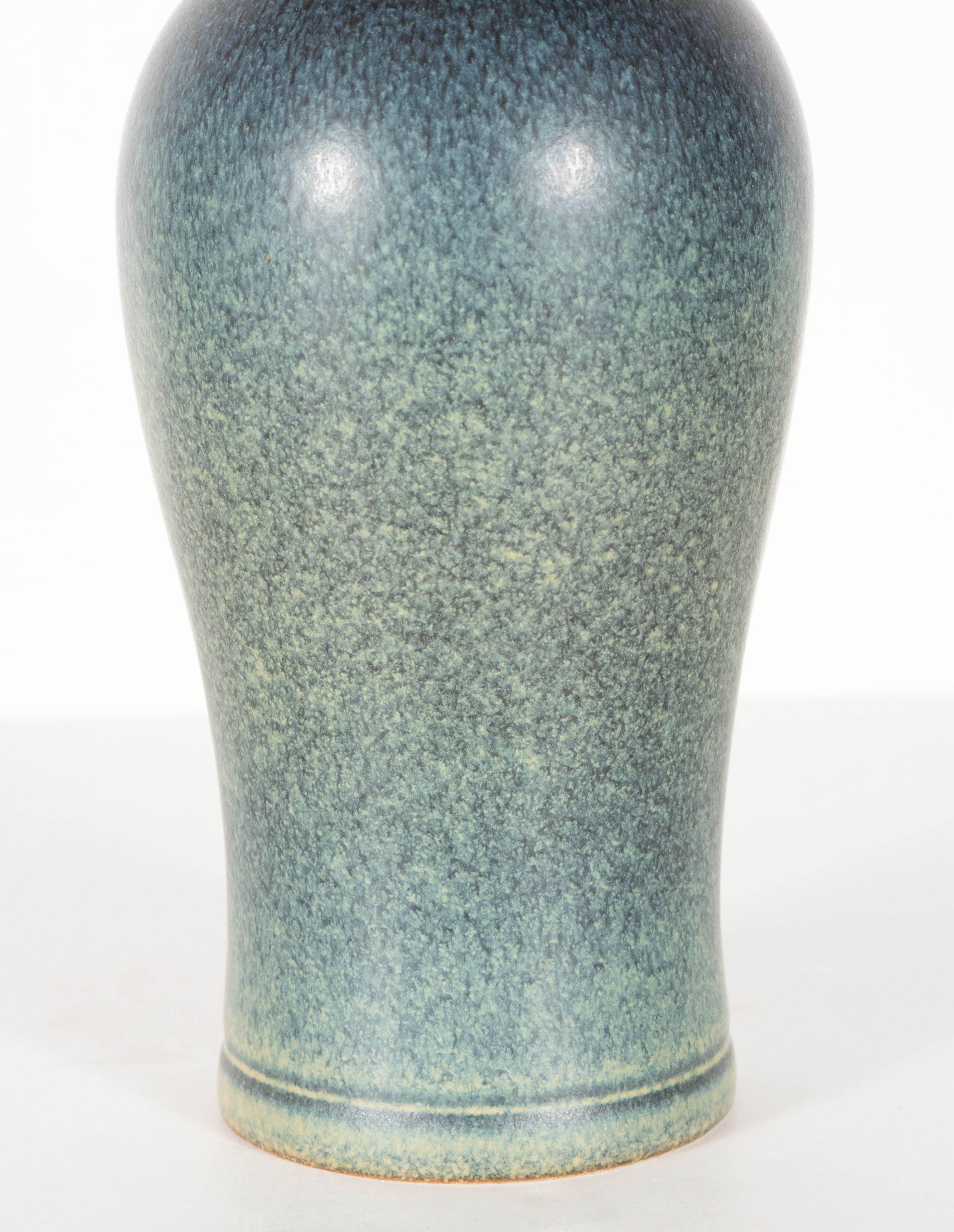 A gorgeous Mid-Century Modernist vase in hues of green and blue by Swedish ceramicist Gunnar Nylund for Rörstrand. A lovely piece on its own or folding a single stem of flora. This piece is in excellent condition.