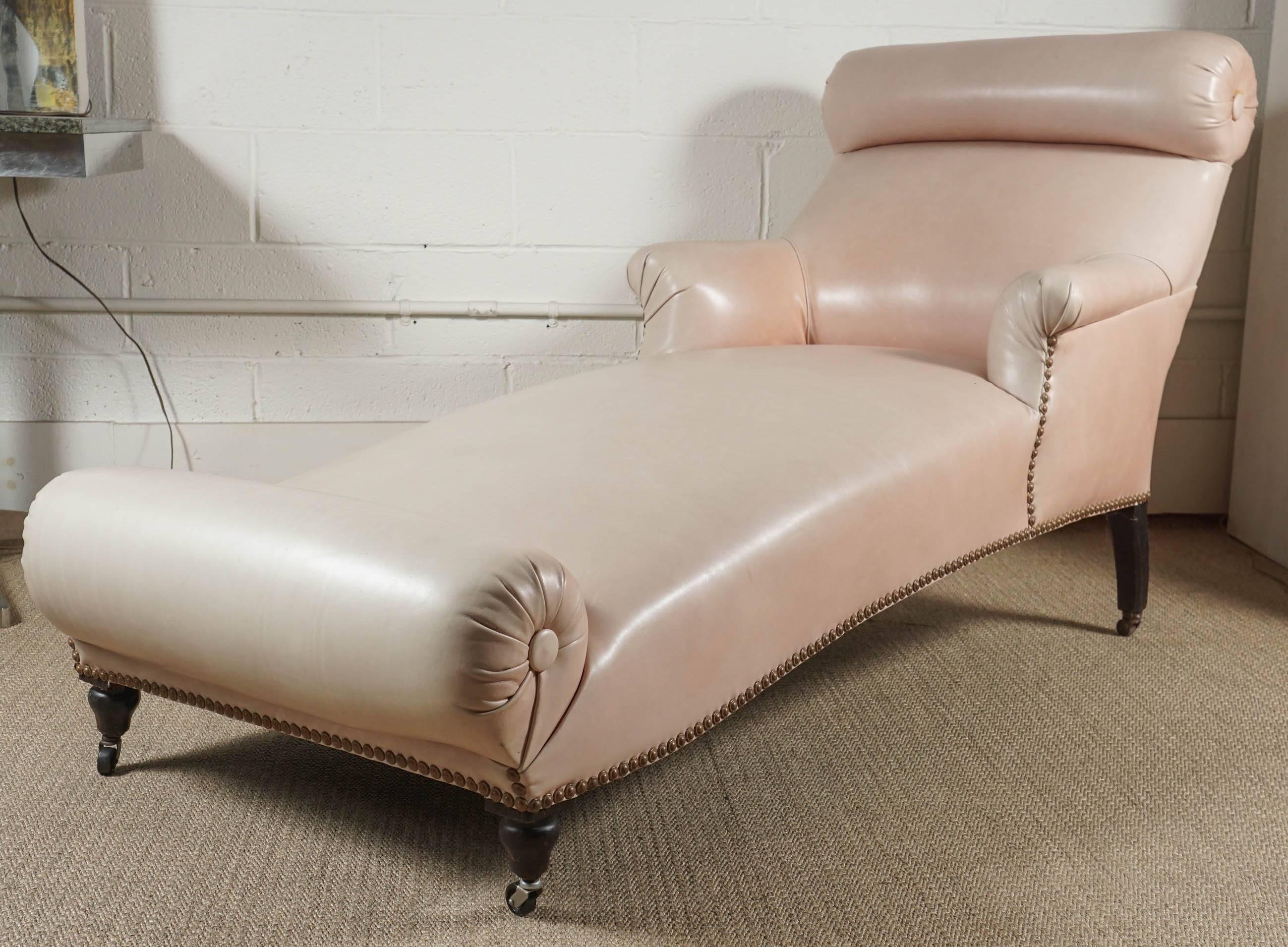 Here is an elegant Napoleon III double bolster chaise that has been upholstered in a salmon colored Edelman leather. Stylish and chic, this antique chaise has a modern look. 