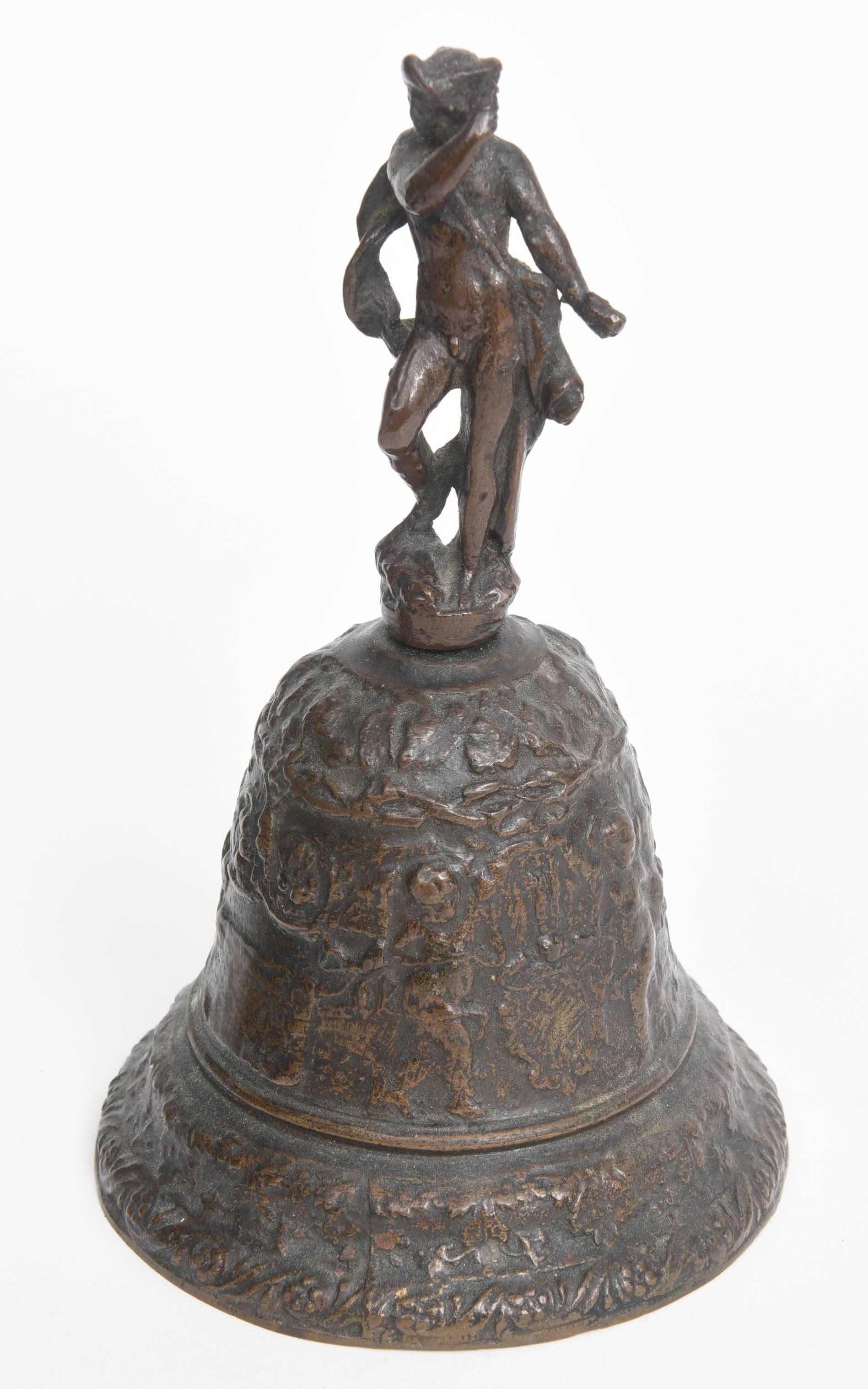 These bronze cast bells are of the type made in Venice in the 16th century.  Both are topped with figures of Mercury.  The larger of the two bells is decorated with reliefs of putti and garlands.  It measures 7