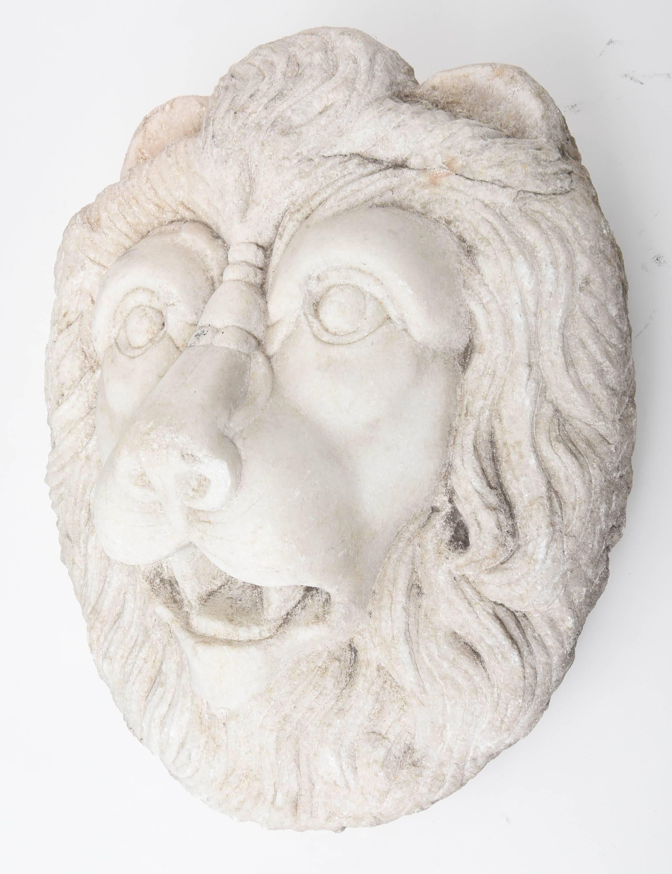 Carved Marble Lion Head with highly articulate mane and a lively facial expression.  This sculpture could be used as a fountain head by drilling out the mouth or as an impressive wall hanging or tabletop item.