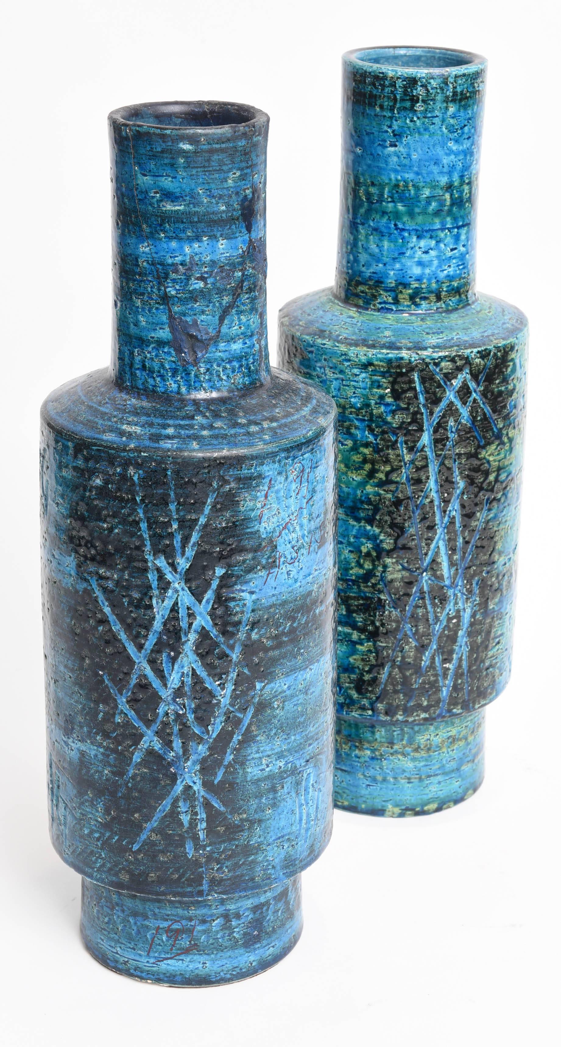 Rare pair of Rimini blue brutalist style blue vases by Bitossi designed by Aldo Londi for Raymor in his signature sgraffito style with paper label on bottom.  These were imported by Raymor and Rosenthal for the United States market in the