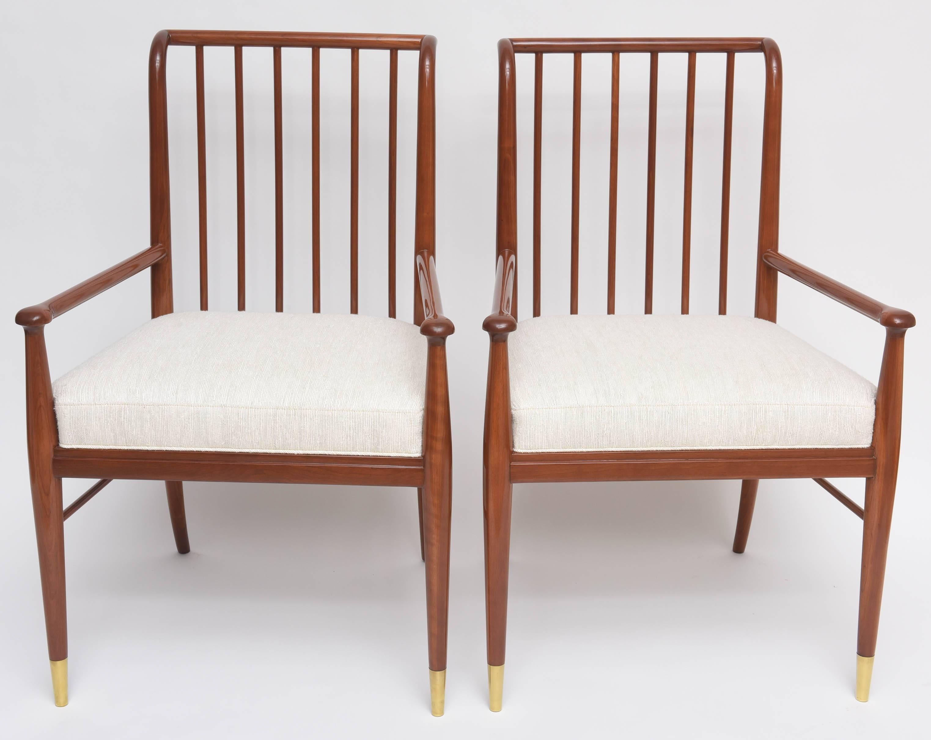 Handsome pair of armchairs by J. Stuart Clingman for Widdicomb. Piano-finished walnut frames with polished brass sabots and new silk upholstery.