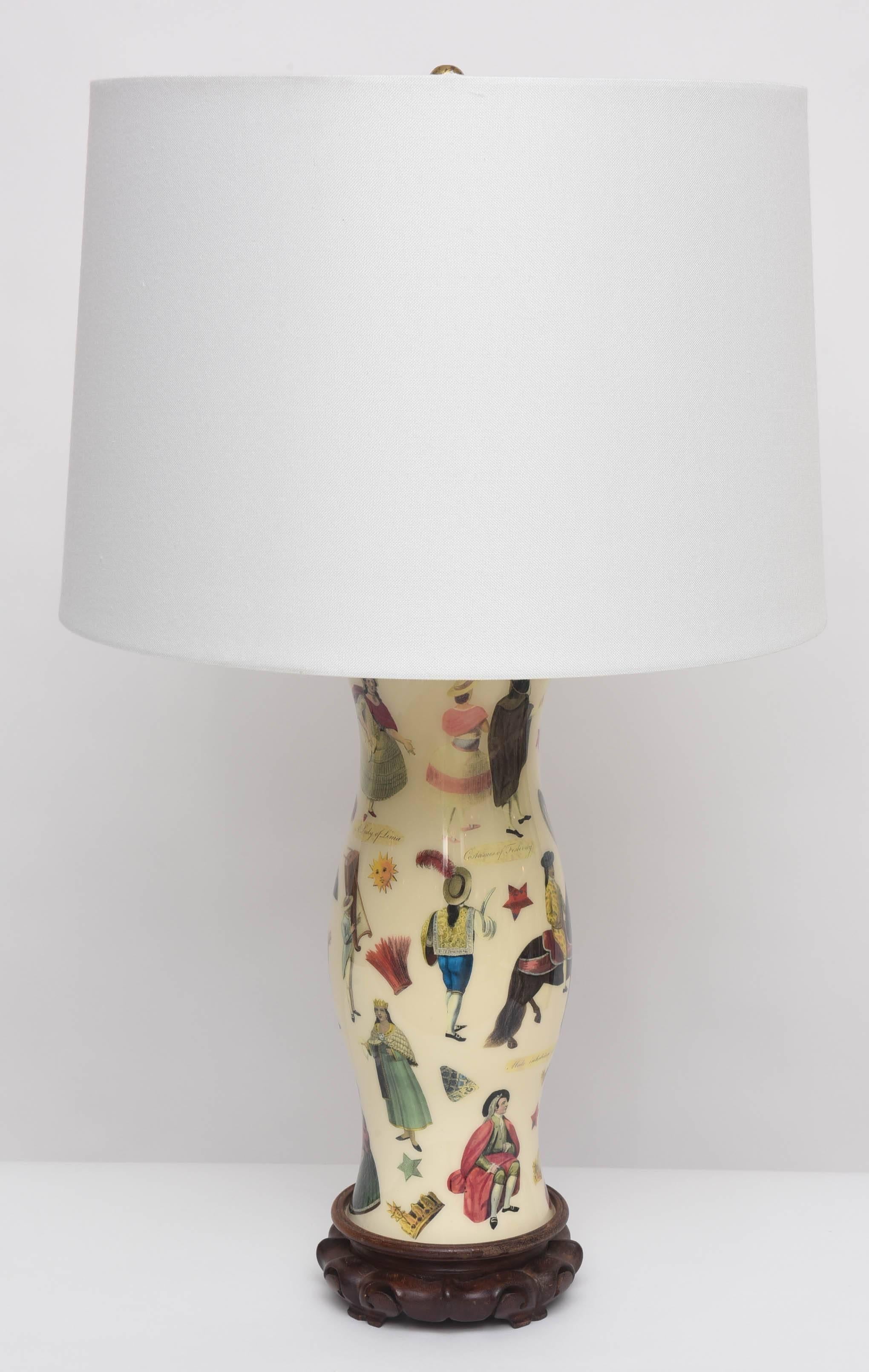 This wonderful and whimsical pair of 1960s decoupage lamps from a Palm Beach estate has a Spanish colonial theme with pastel-hued transfer prints of Peruvian grandees, fashionable women of Lima, native Incans, and llamas on a cream background. Brass