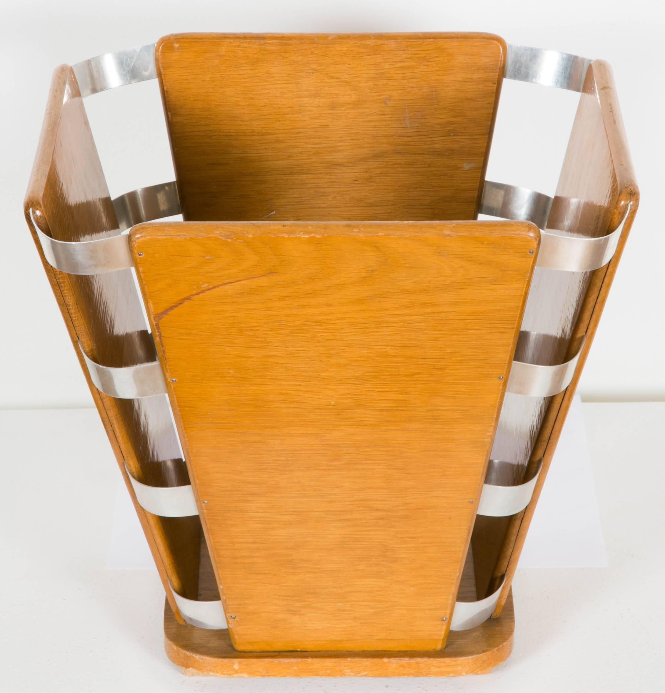 An art deco waste paper basket by Ruhlmann from the 1930s.
Plywood and chromium plated metal.
