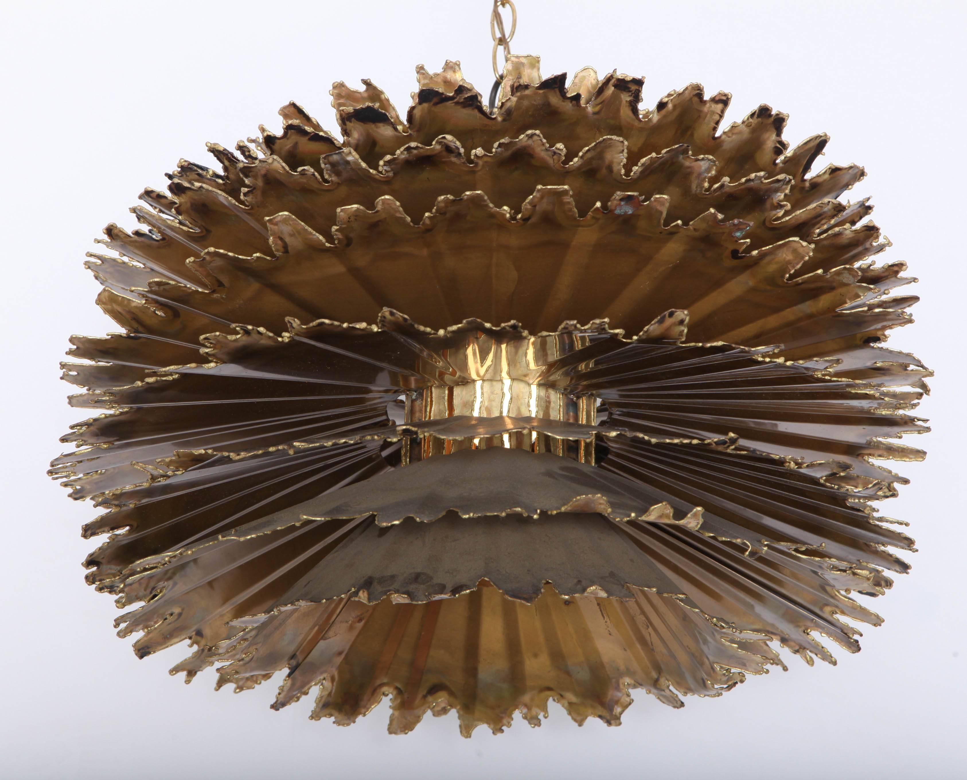 Torch-cut and patinated brass flower-form chandelier by Tom Greene for Feldman lighting, Los Angeles, ca 1970. Chandelier body 22