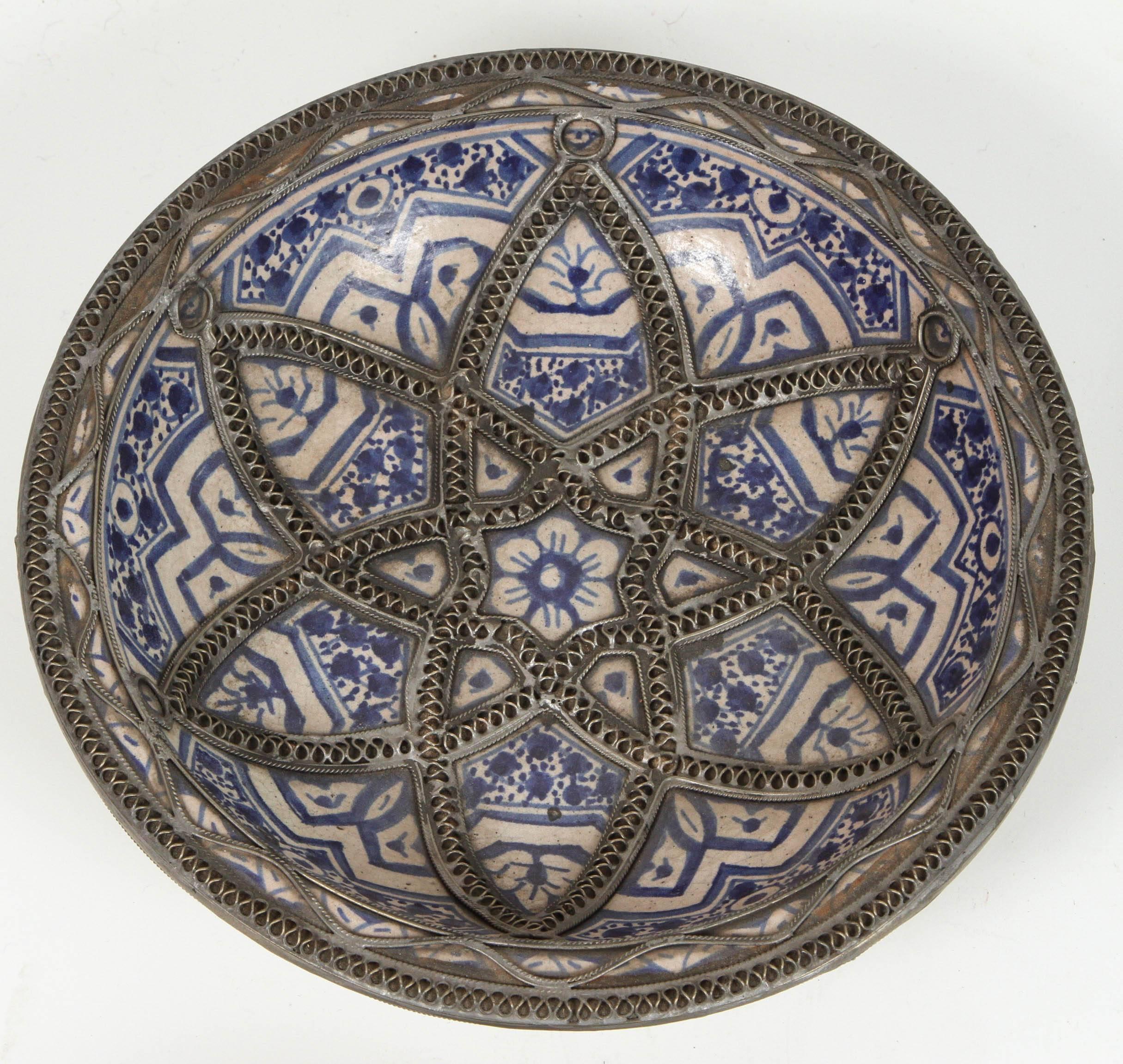 Hand-crafted set of four Moroccan decorative ceramic plates from Fez.
Hand-painted in Bleu de Fez, very nice designs hand-made by artist in Fez.
Geometrical and floral designs and adorned with nickel silver filigree designs.
Could be hang on the