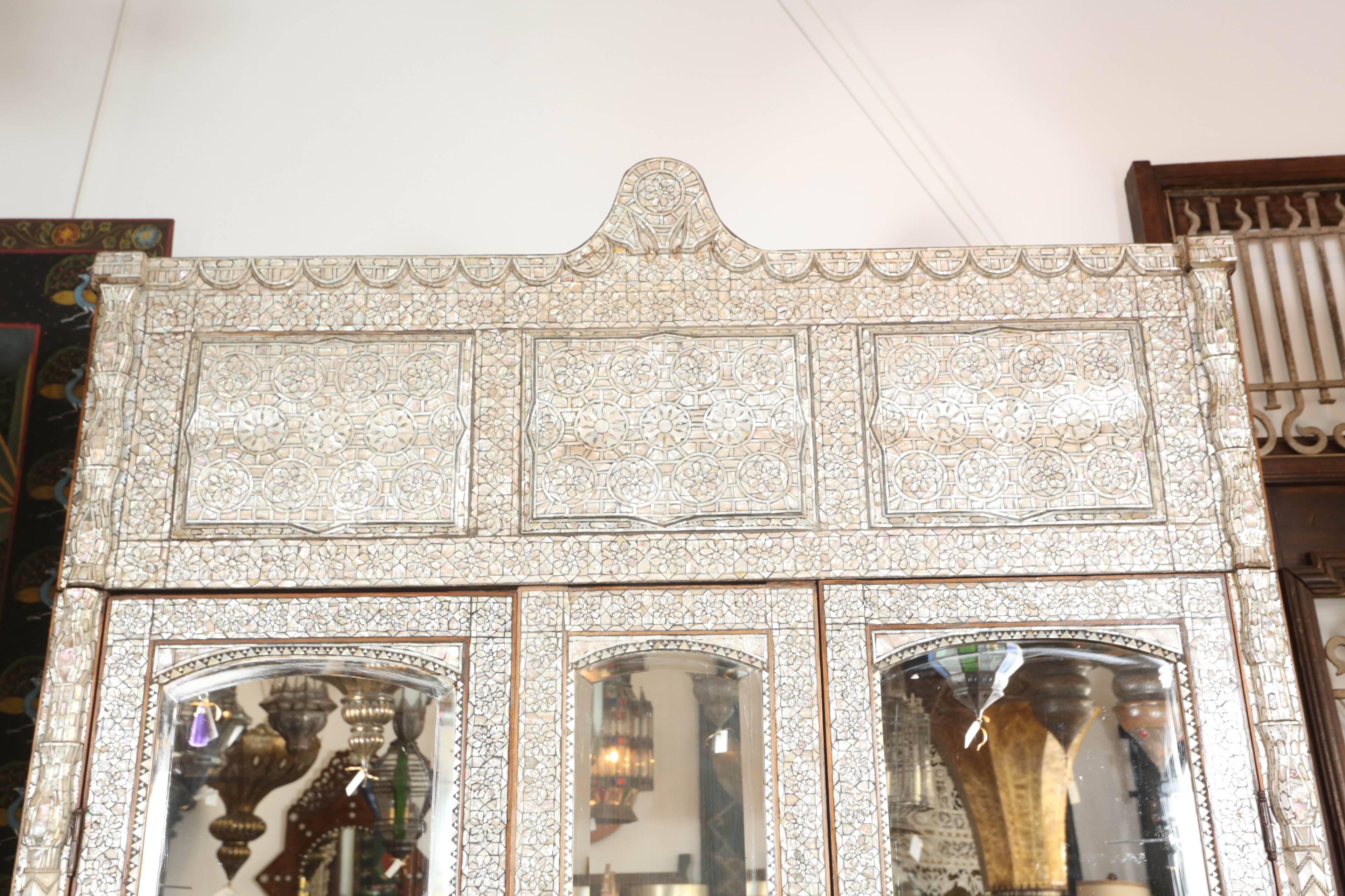 Antique 19th century Middle Eastern Syrian armoire with mirrored doors and drawers.
One of a kind gorgeous handcrafted armoire inlaid with mother-of-pearl and ebony in Florentine and Moroccan Moorish intricate designs.
Each piece pf shell was