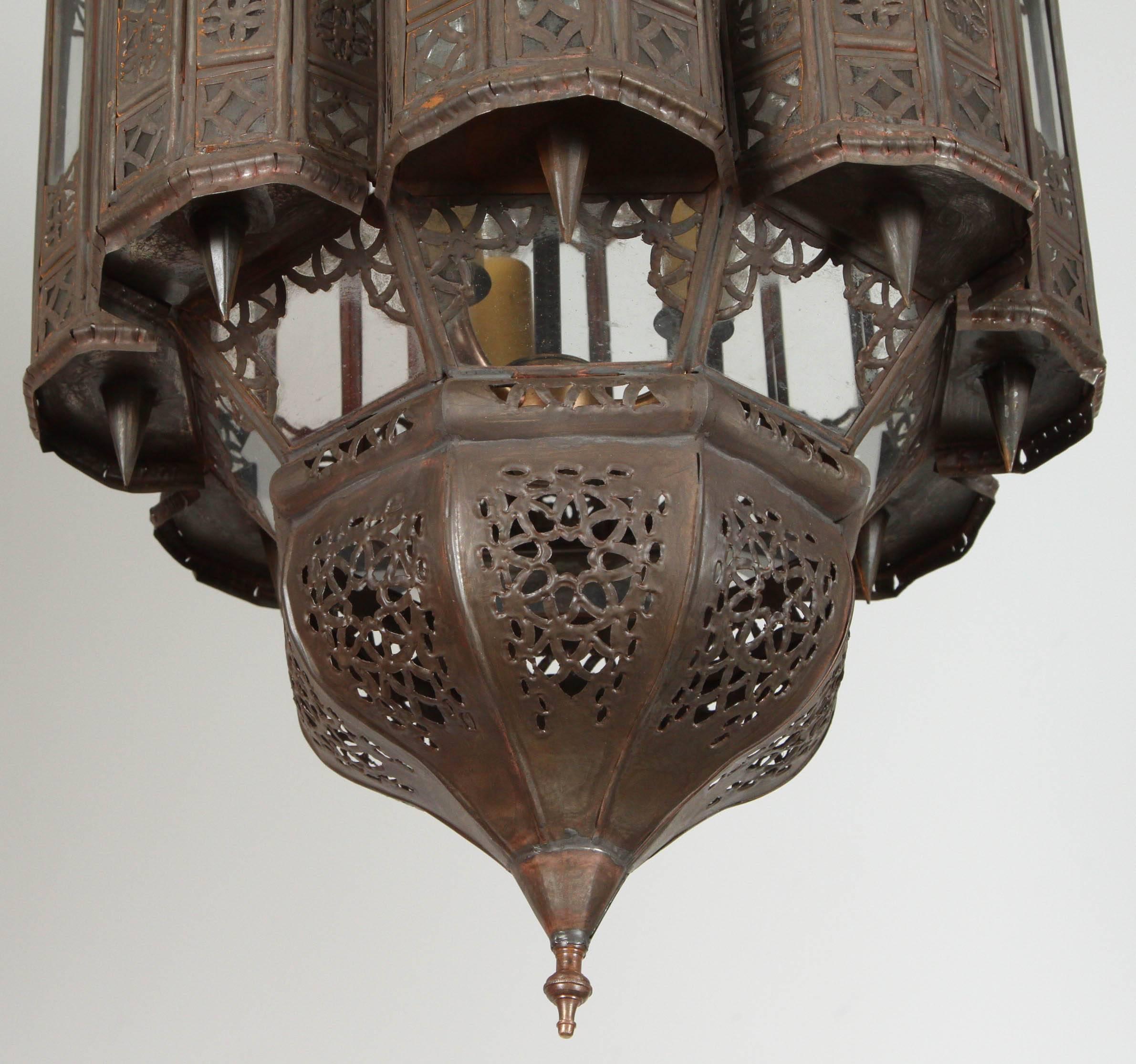 Moroccan handcrafted Mamounia pendant.
Mamounia lantern handmade in Marrakech, very fine Moorish filigree metal hand-cut in Moorish designs, clear glass patterned.
Rewired in the US for three light bulbs.
Comes with chain and canopy ready to