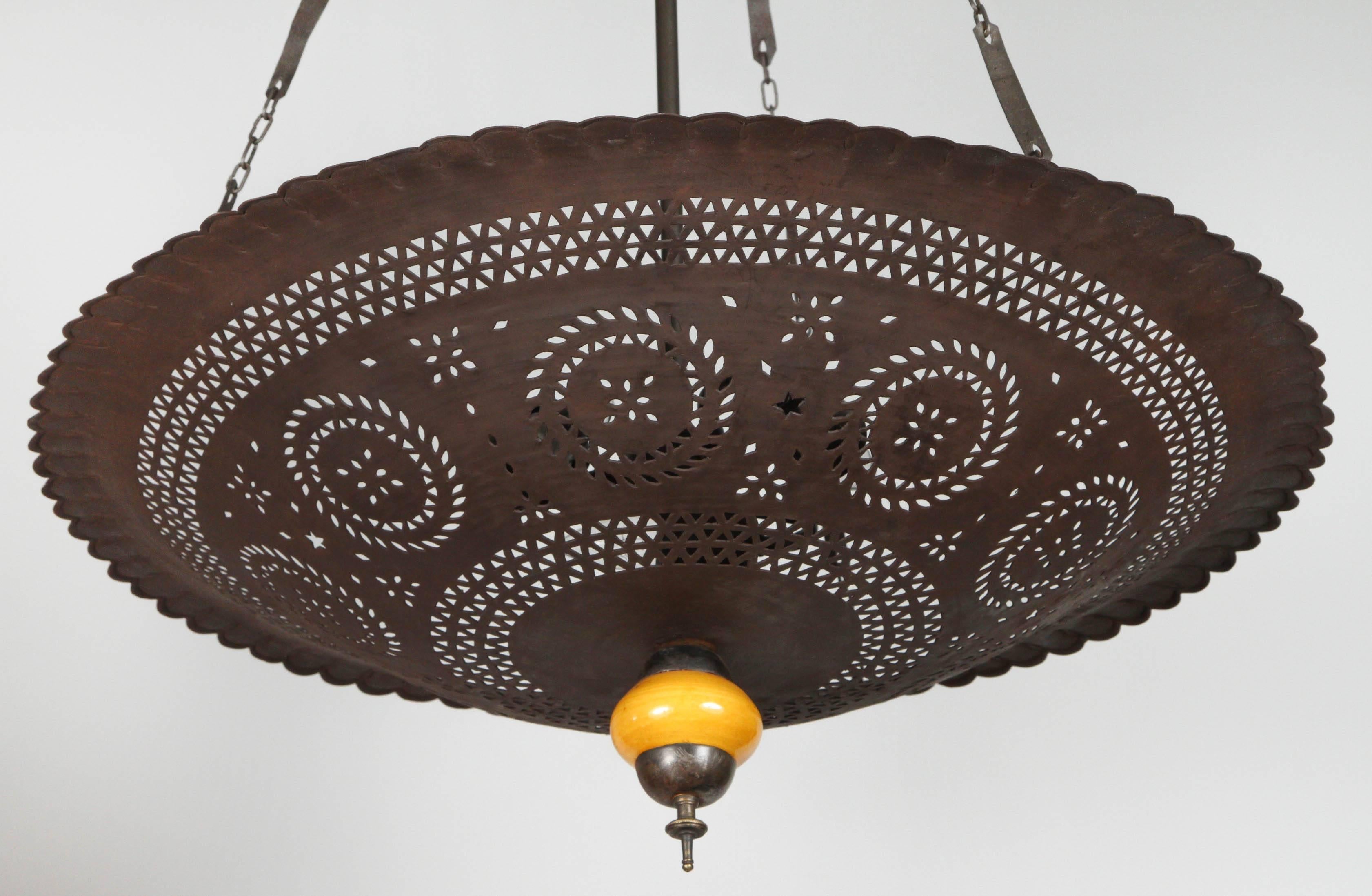 Moroccan hanging chandelier handmade with nice intricate geometric Moorish fretwork cut-out and a yellow  ceramic porcelain final.
Rewire with three lights, ready to hang, great to use in a Spanish Mediterranean style home or in a Modern design