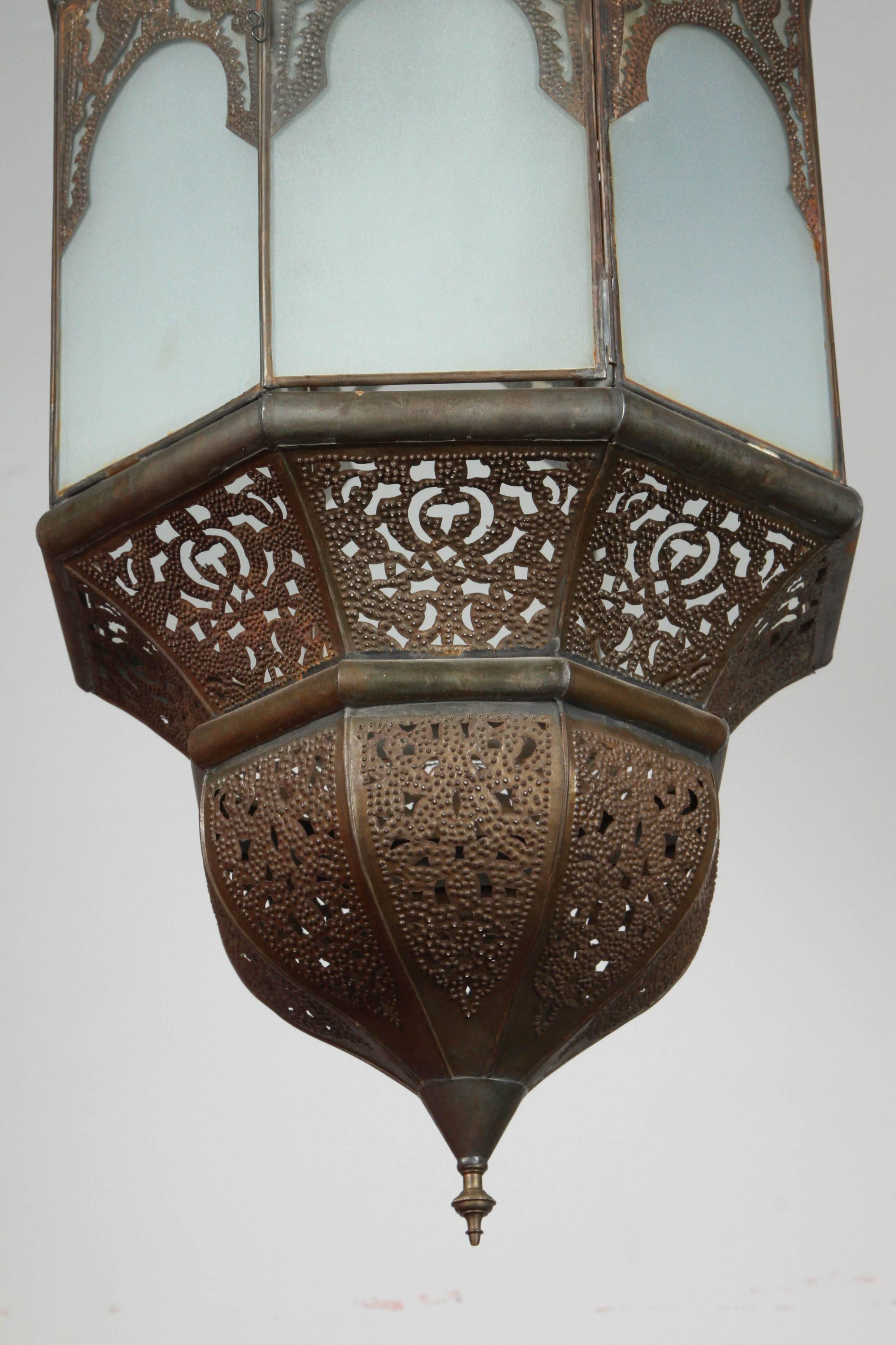 Moroccan Moorish hanging glass pendant from Marrakech with sandblasted glass in frosted milky glass with bronze color metal finish.
Rewired and has a small door on the side to change the light bulbs.
Handcrafted pendant by artisans in Morocco.
Body