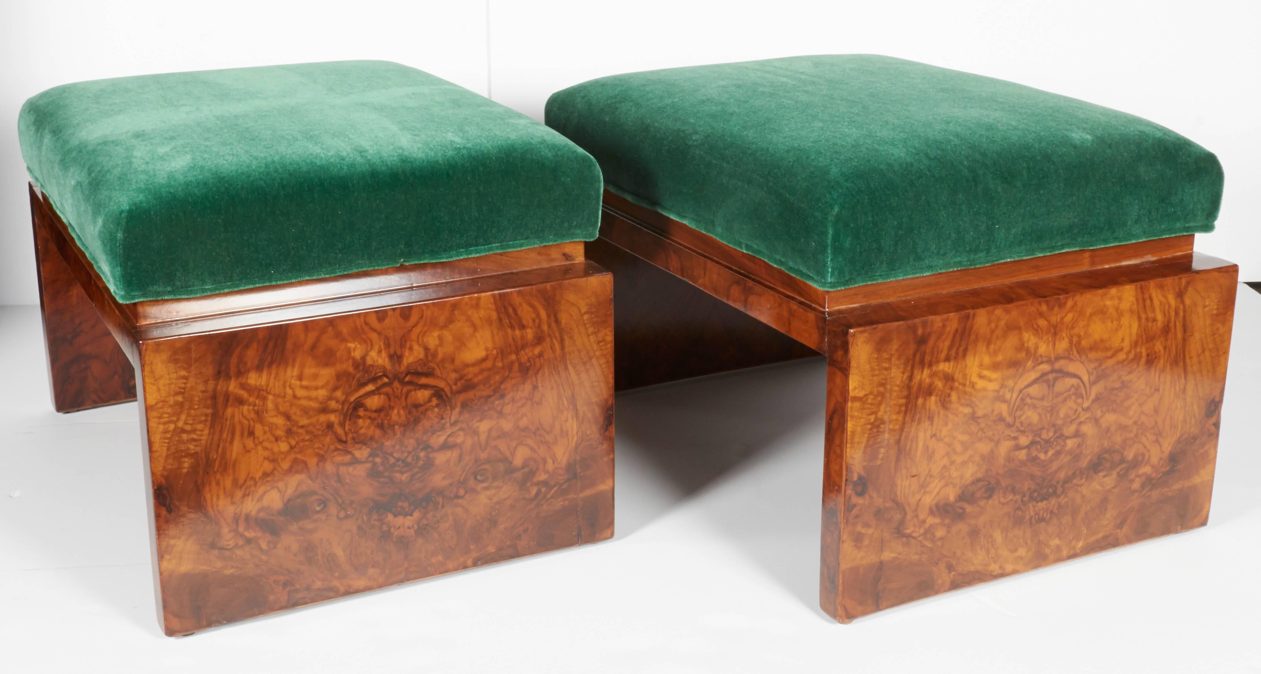 Exquisite English deco benches in bookmatched burled Carpathian elmwood. The benches feature a streamline base design with rectangular cushions, newly upholstered in luxurious emerald green mohair. The benches can also serve as ottomans. Rich in
