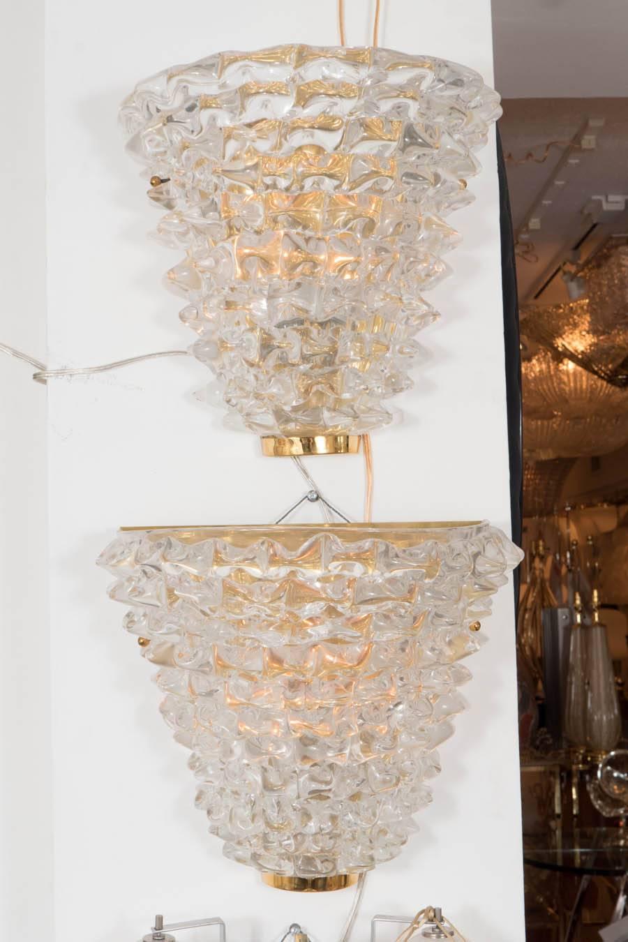 Pair of clear spiked Murano glass sconces with brass hardware.