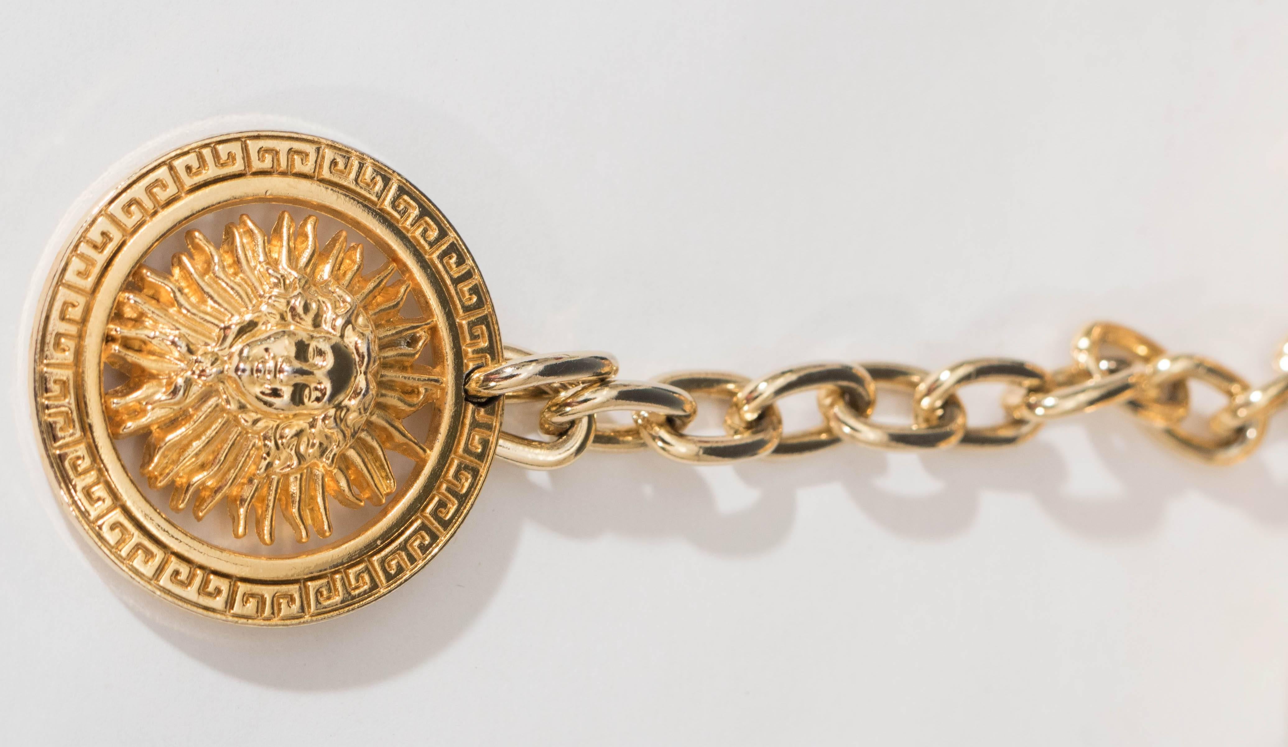 This gorgeous Versace belt in genuine black leather, made circa 1990s, perfectly narrates the timeless style and taste of the Italian fashion company, accented with iconic gold Medusa medallions and chain. Markings include [Made in France] stamped