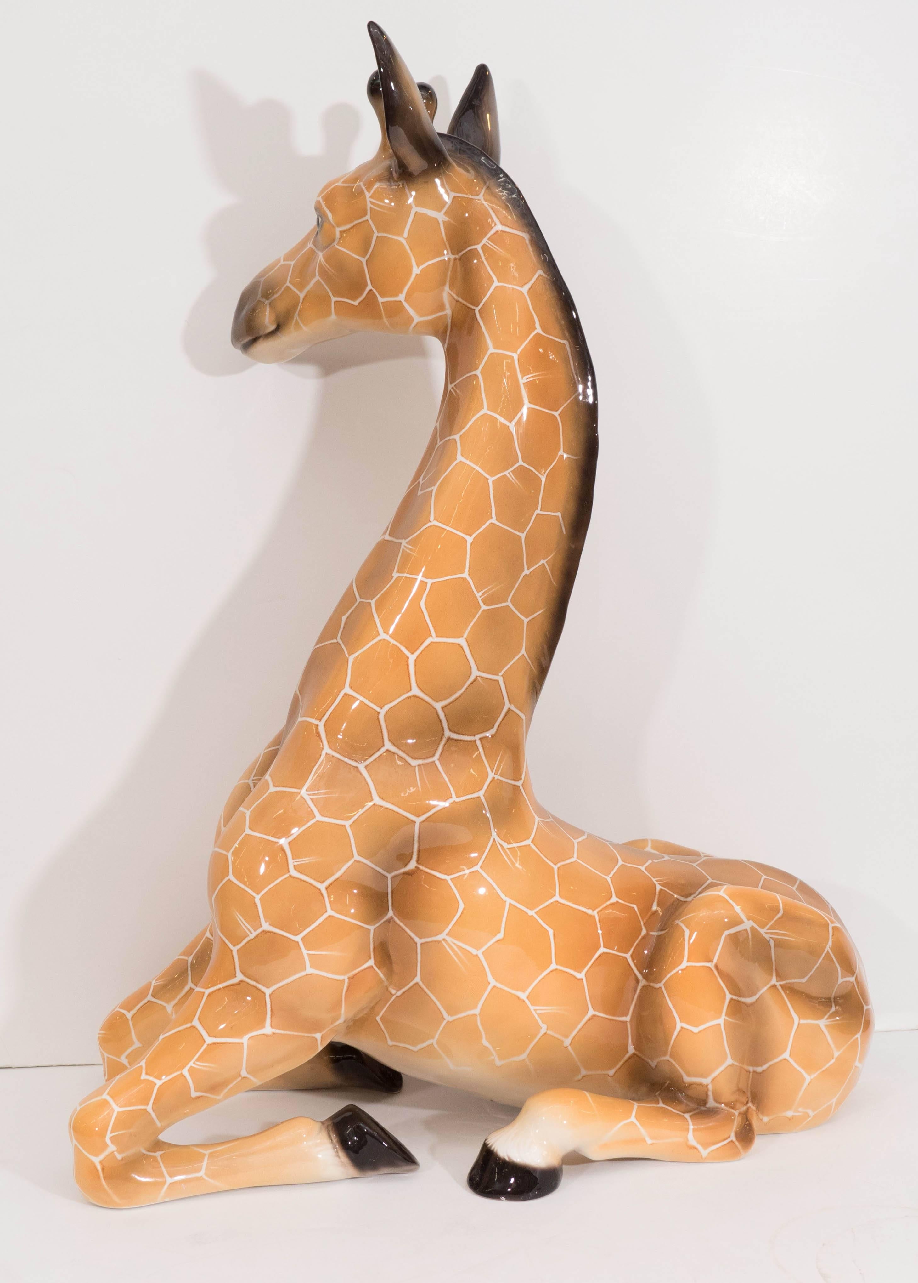 A large scale vintage sculpture of a giraffe, produced in Italy, circa 1970s, in glazed ceramic, aqua airbrush applied for fine shading and details. Markings include stamp [Made in Italy] and [P] etched to the bottom of the piece. Very good