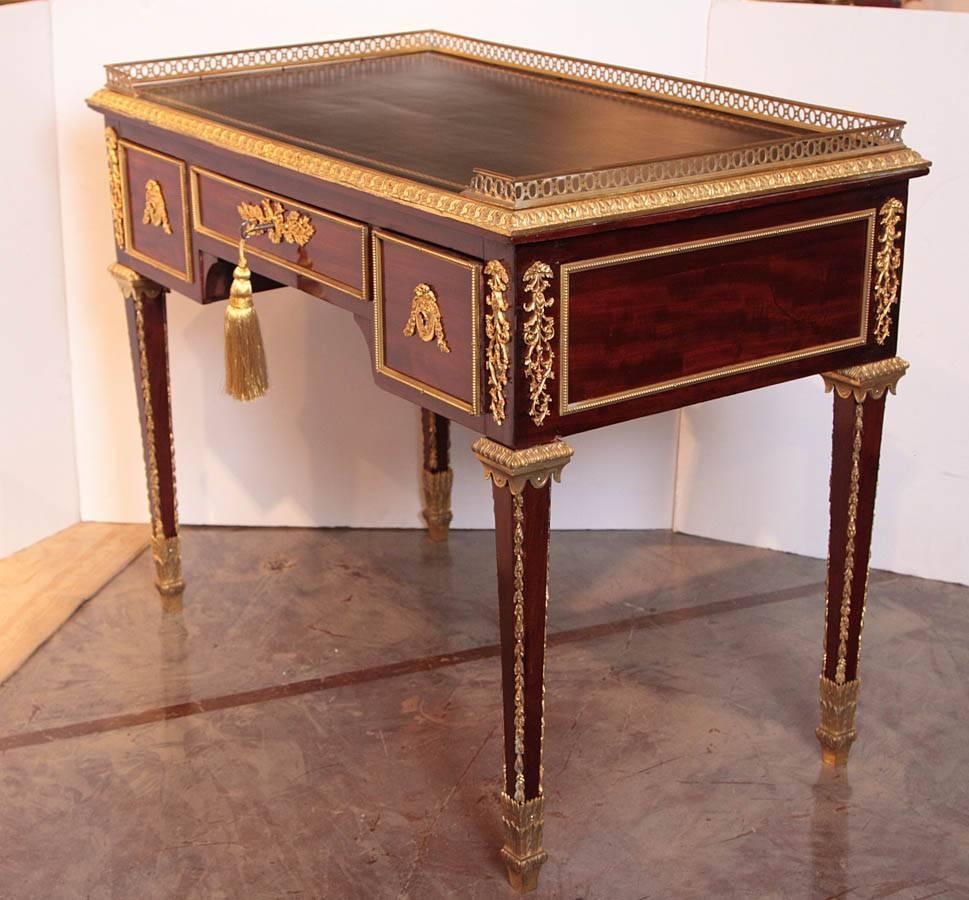 Late 18th century French Louis XVI mahogany and gilt bronze writing desk. Leather top gilt bronze gallery. Fine quality.
