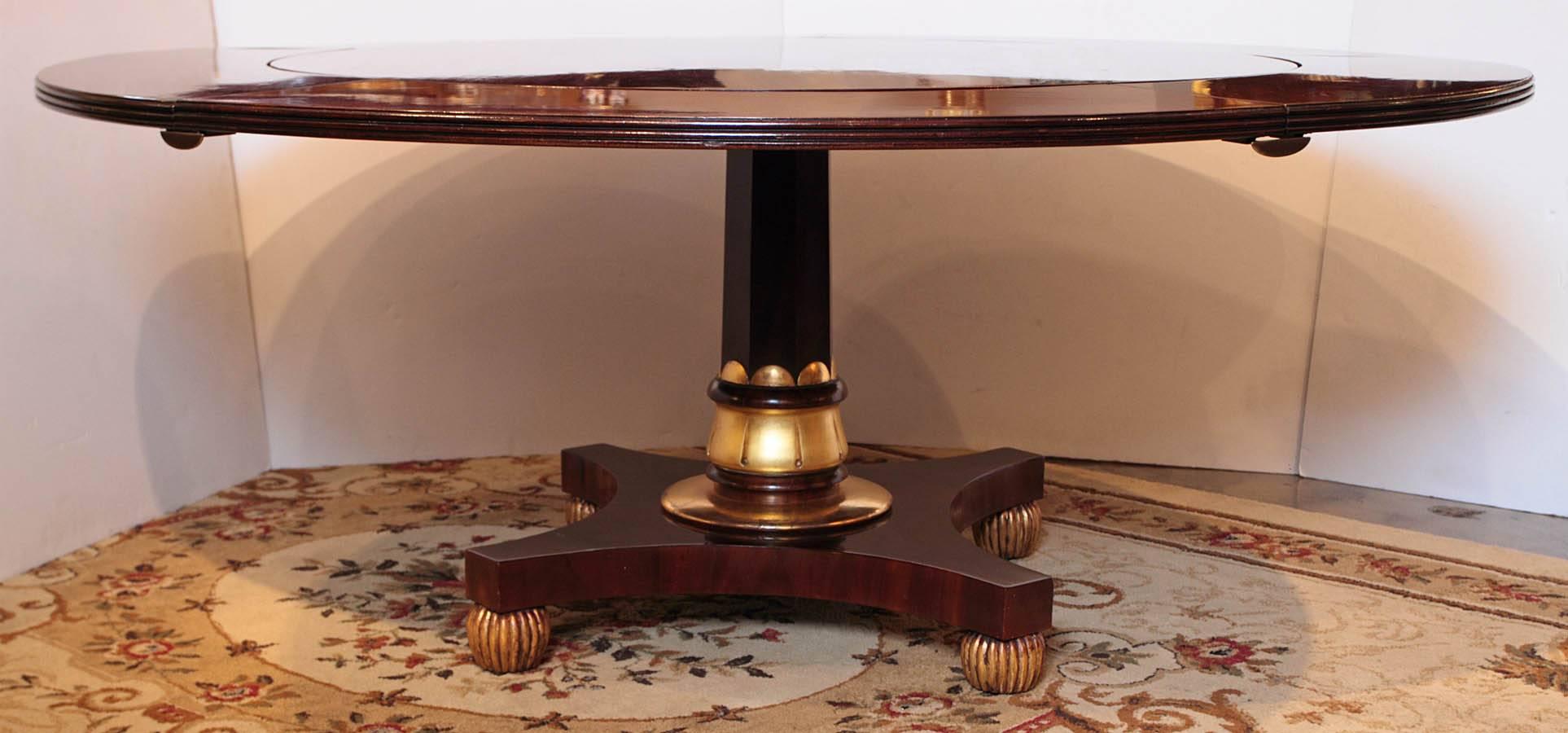 19th century Regency mahogany and parcel-gilt dining table. Original extension leaves.