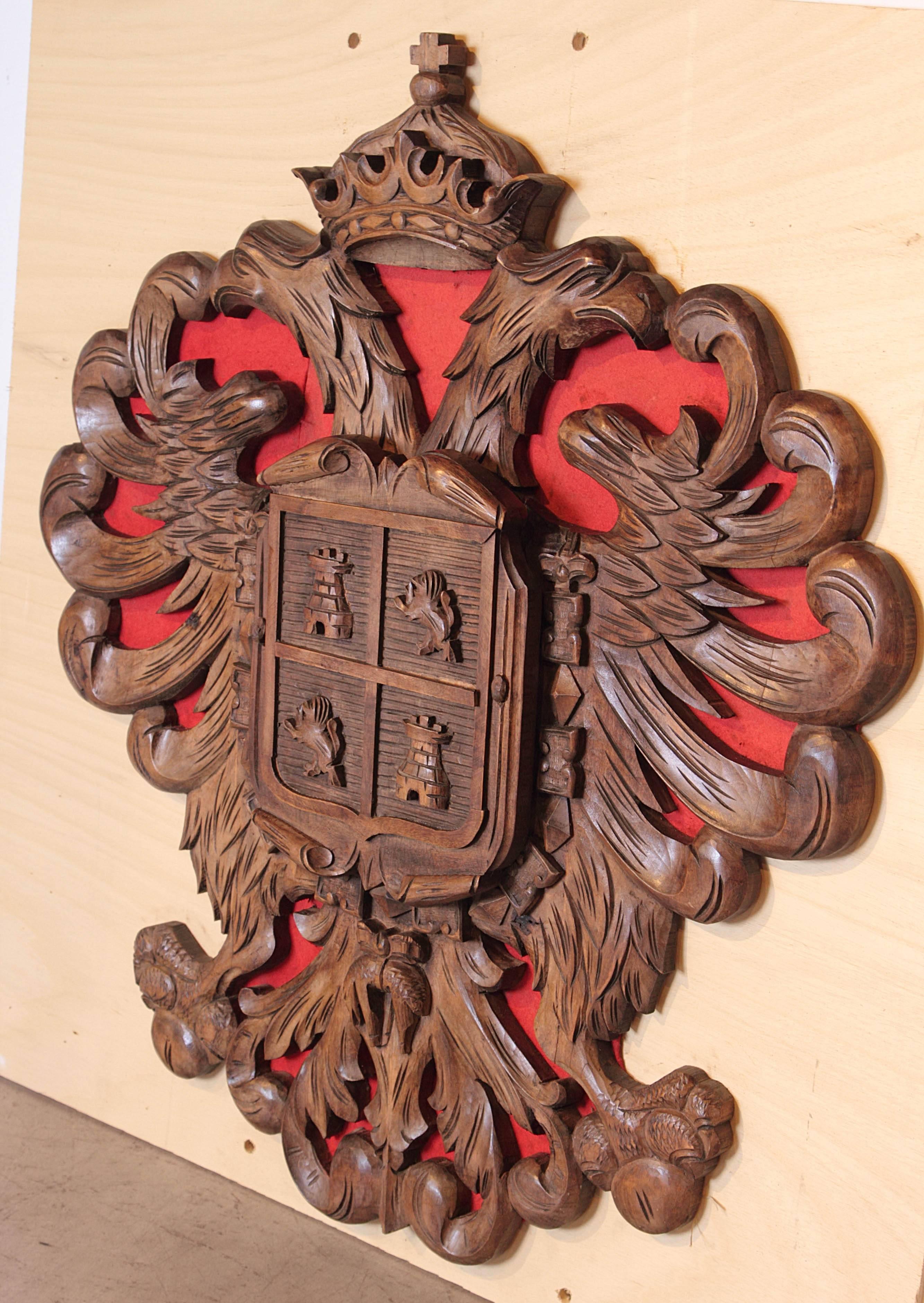 This antique oak coat of arms depicting a twin headed eagle has its roots as an emblem of the Byzantine Empire. One head is turning to Rome in the West while the other head turns to Constantinople in the East. The twin headed eagle can be found on