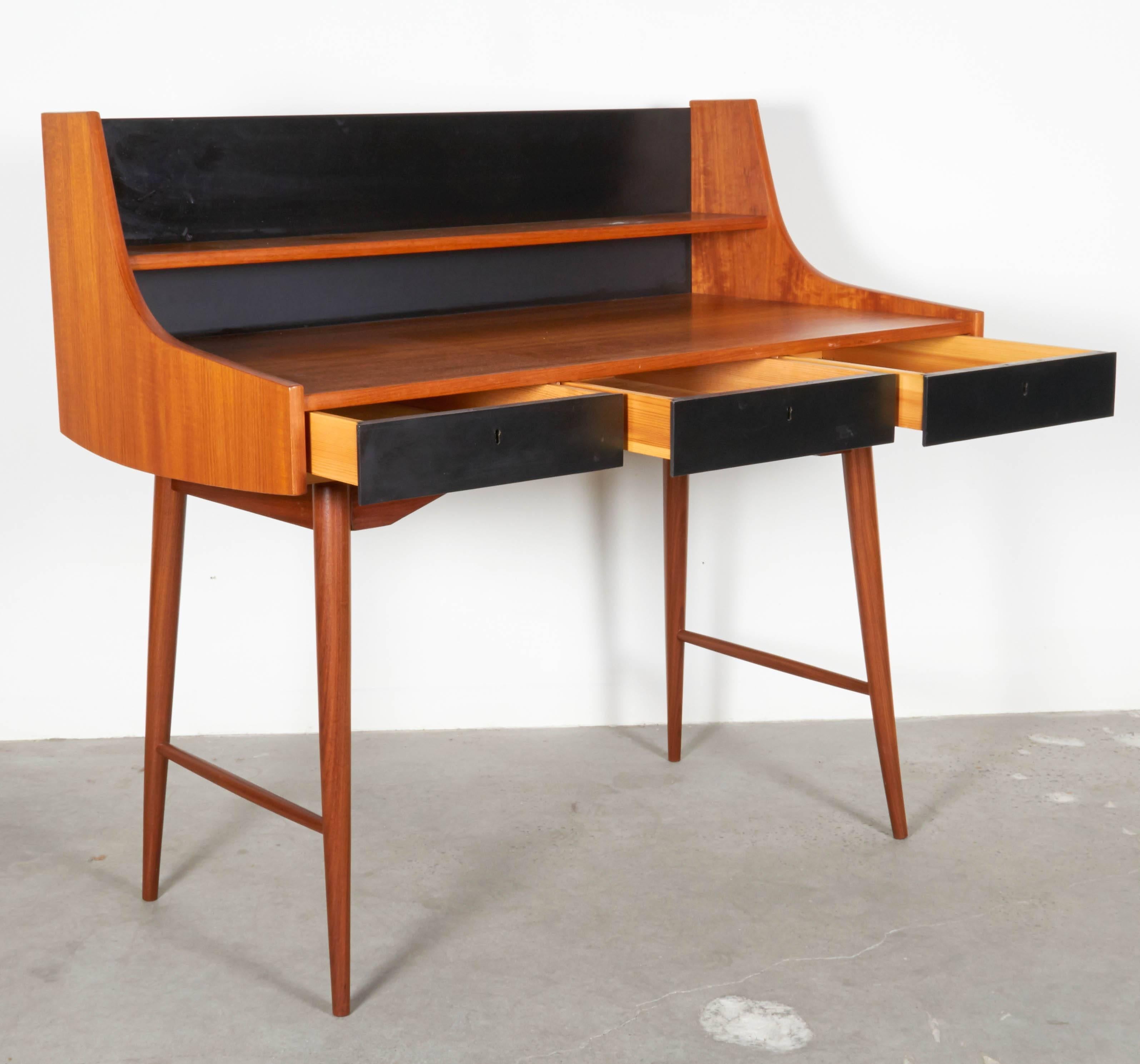 Vintage 1950s Writing Desk by John Texmon 

This writing desk is in like new condition. There are three black painted drawers side by side on the front. Middle draw locks and we have the key. The tranquil yet elegant design would be lovely in any
