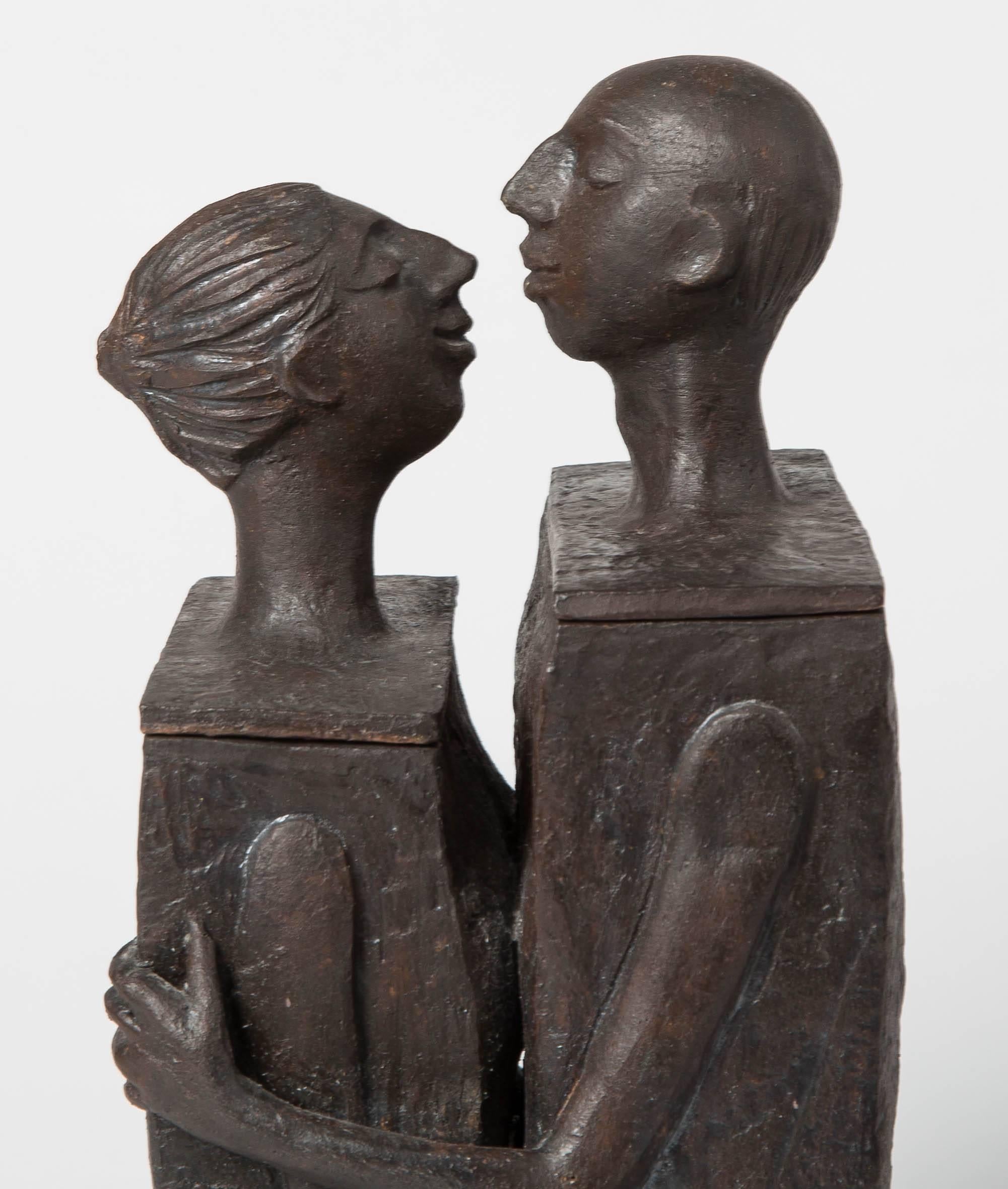 Embracing male and female ceramic figural lidded box sculpture.