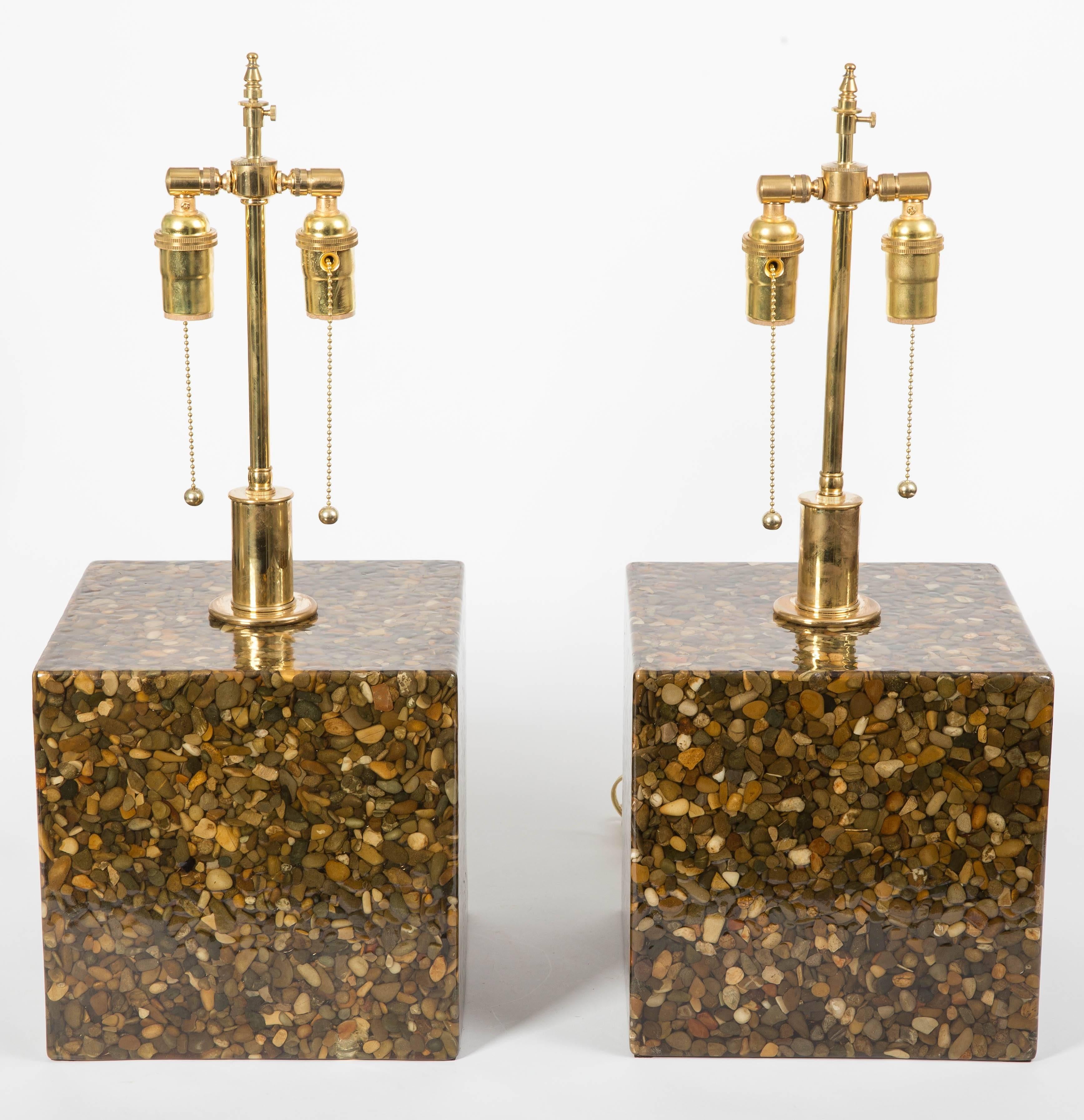 Pair of cubic resin and pebble lamps with brass hardware.