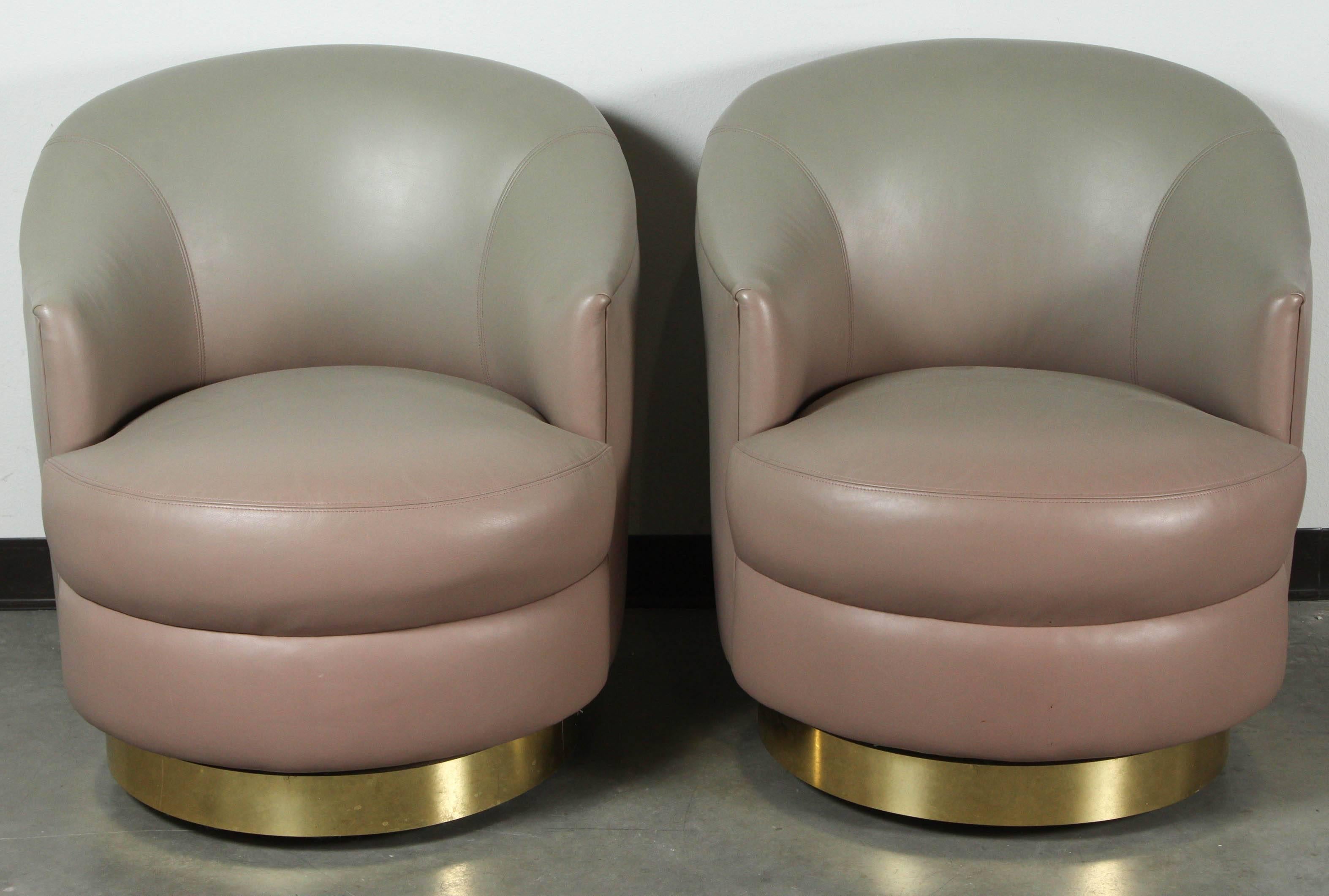 Fabulous pair of Swivel chairs designed by Steve Chase.
The chairs retain their original gray ombre leather that is in near perfect condition and they sit on polished brass bases.
The chairs were acquired from an Indian wells Estate designed