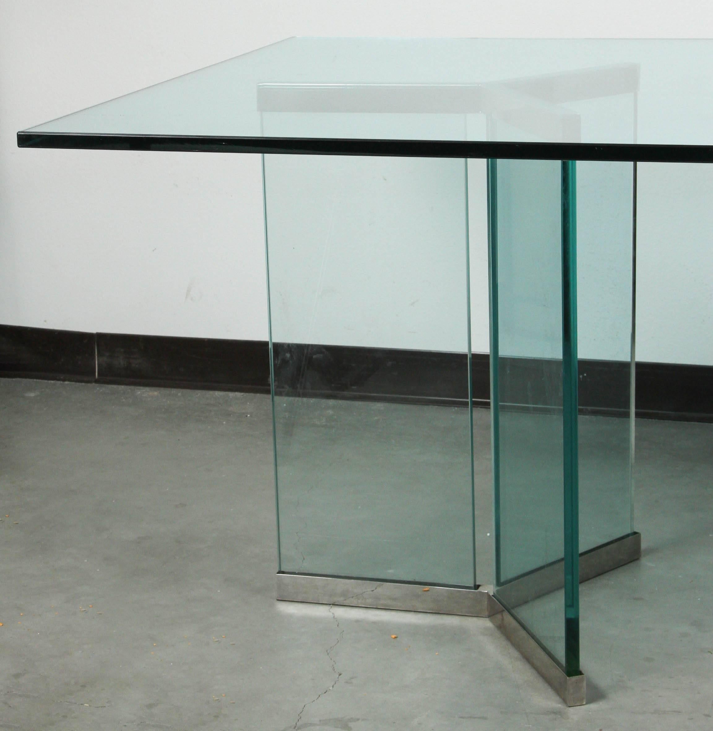 Classes dining table by Leon Rosen for Pace.
Two triangular bases of glass and polished chrome support a rectangular
glass top for a Minimalist look.