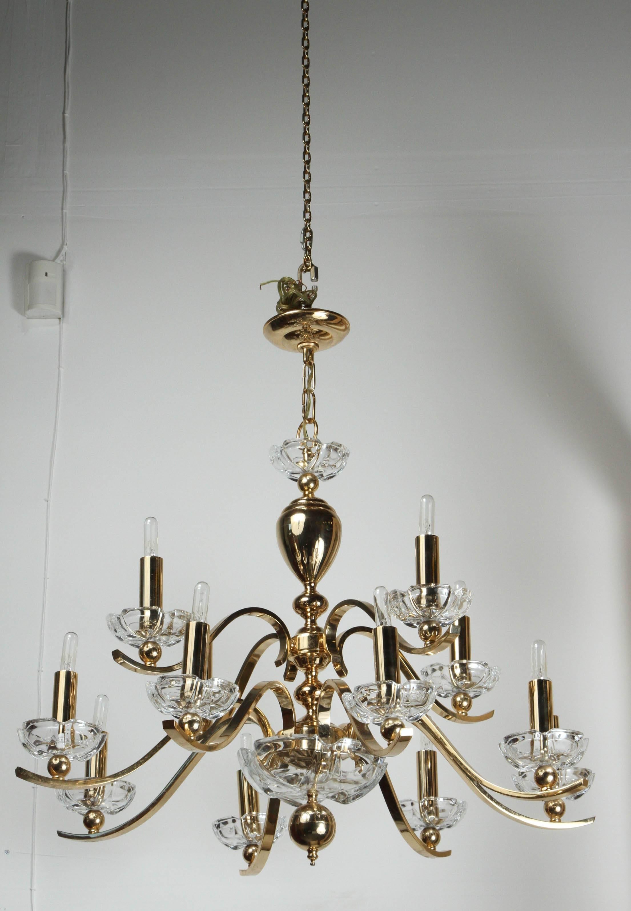 Elegant twelve-arm polished brass chandelier with glass bobeches.
The chandelier is accompanied with matching ceiling canopy.

 