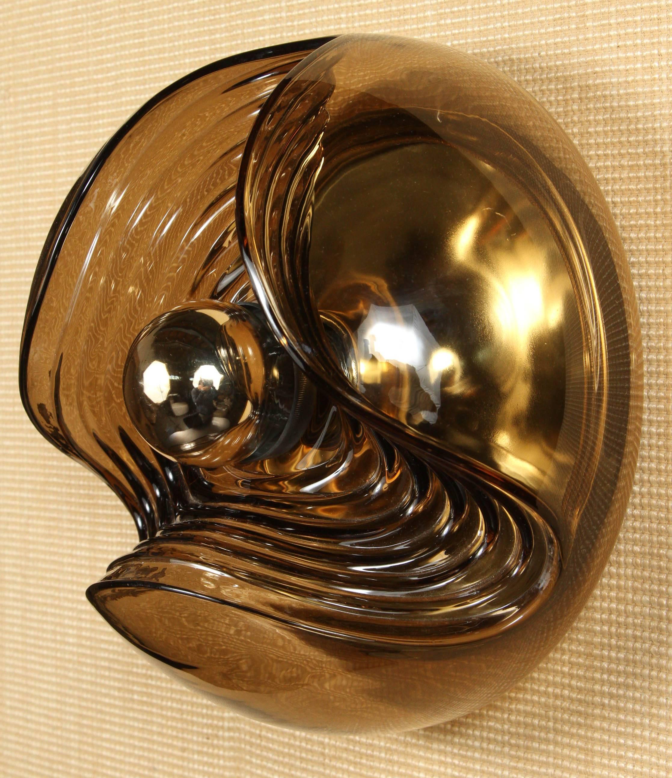 Wonderful 1970s German Space Age smoked glass and brass flush ceiling mount or wall sconce fixture by Peill and Putzler.
The single light source has been newly rewired.