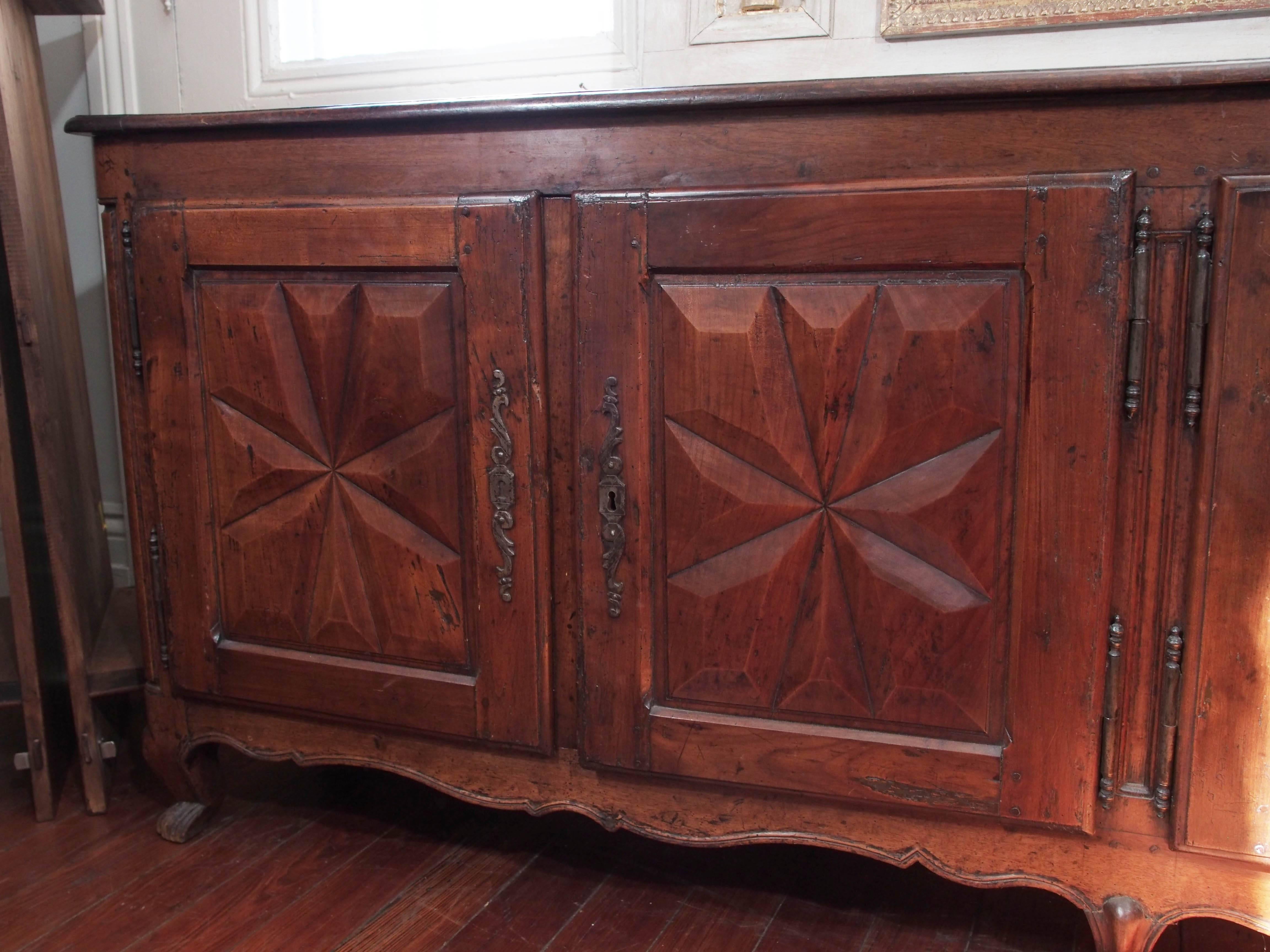 18thCentury solid  walnut enfilade with 4 carved doors ina star motif  and one shelf inside. Scrolled feet