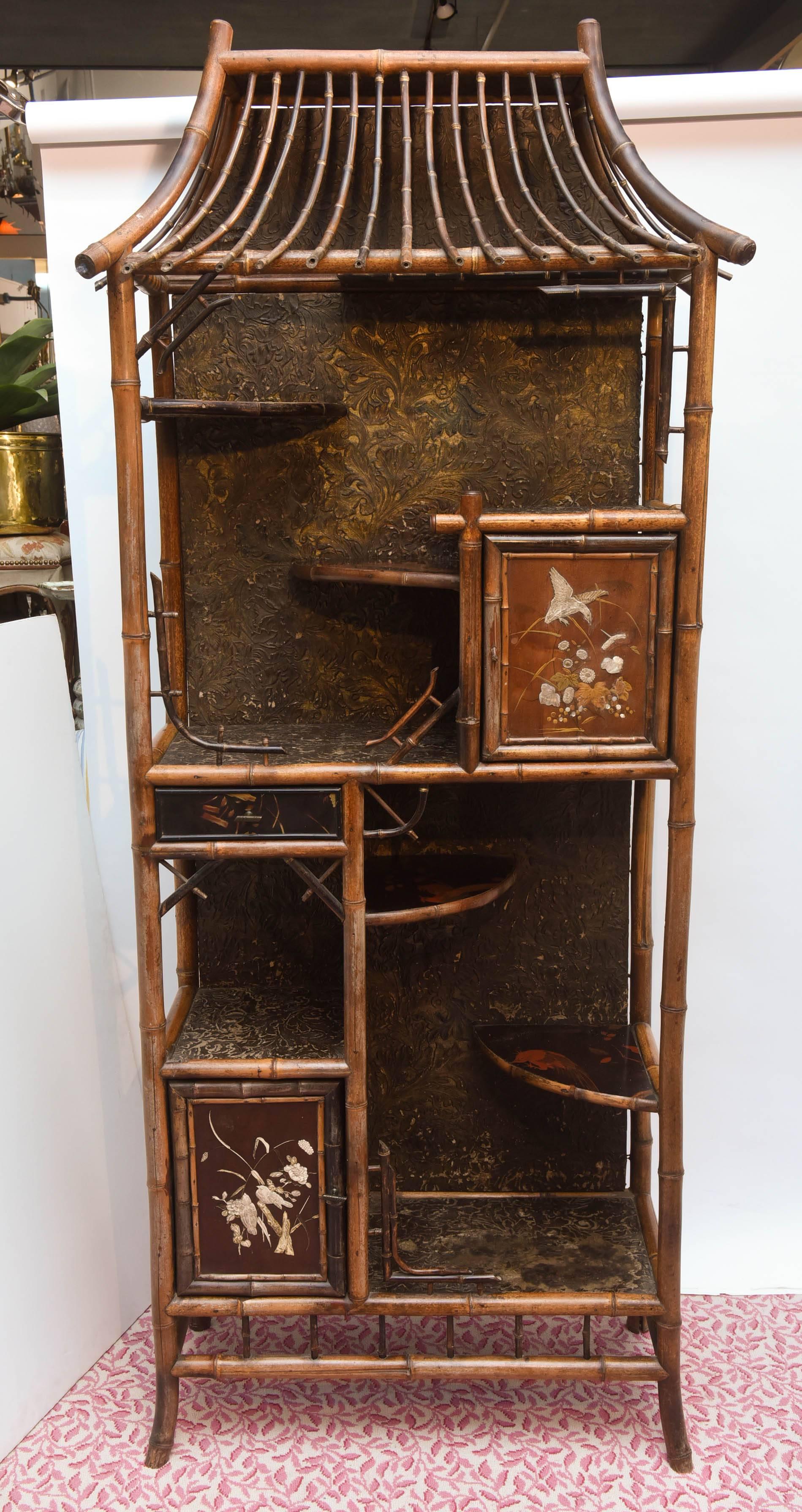 Superbly designed with "staggered" shelves, alcoves and decorated with inlaid doors. An imposing and eye catching prop for any collection.