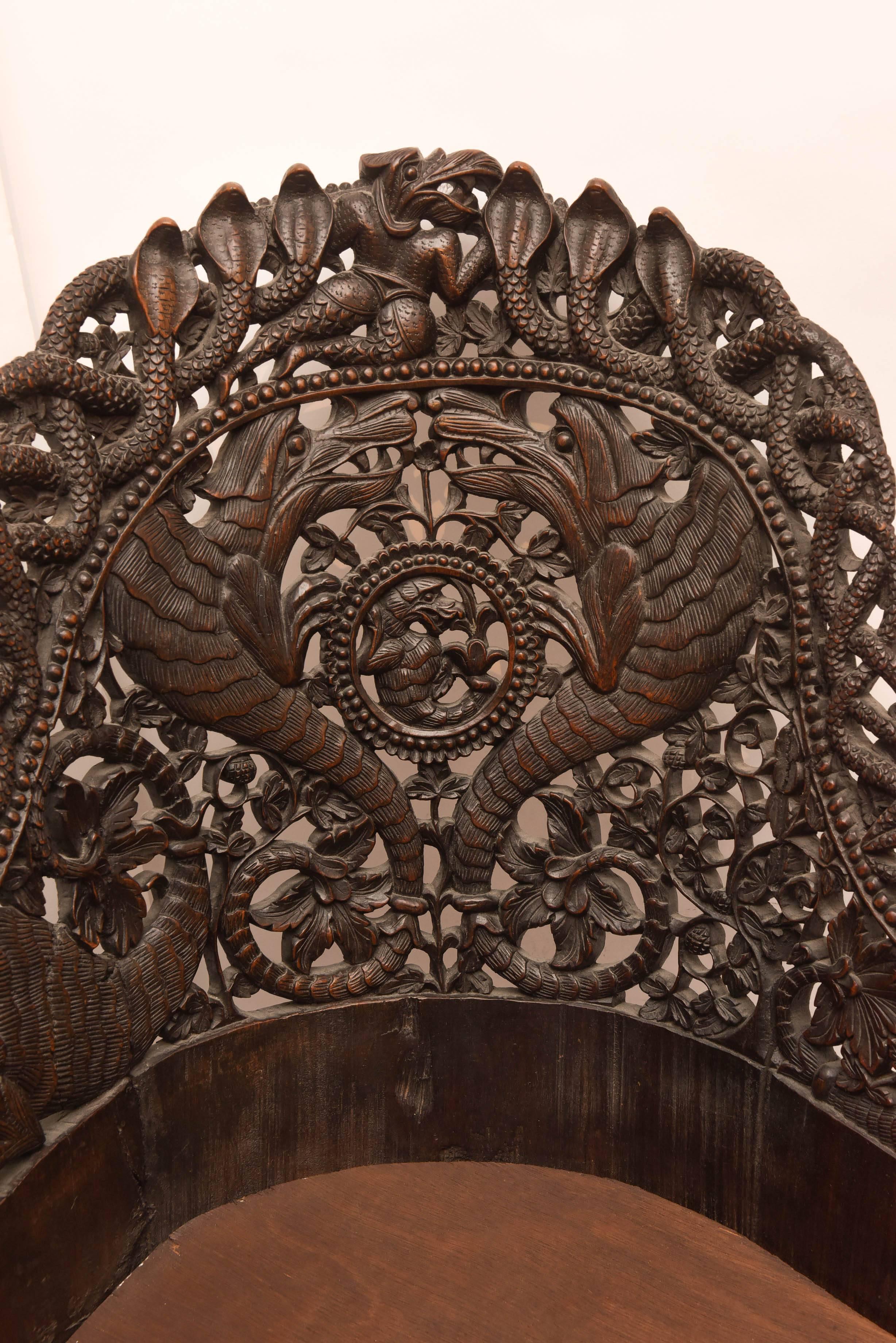Superbly and lavishly carved. Unusual imaginative theme with a "surround" of cobras, intricately carved alligators, tigers and elephant form "feet".