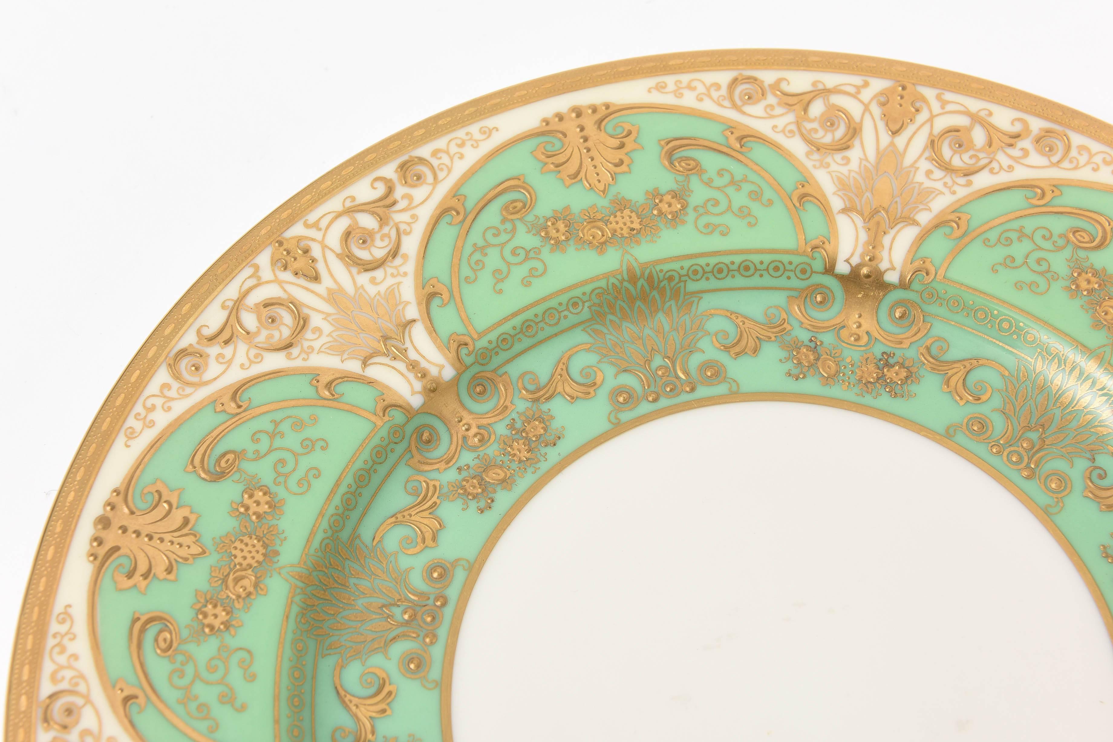 A beautiful design of soft green cartouches set amidst cream with an all over raised paste gilt throughout the collar and graduating into its well. An unique pattern every angle you gaze upon it. Custom ordered through Lenox for the fine antique