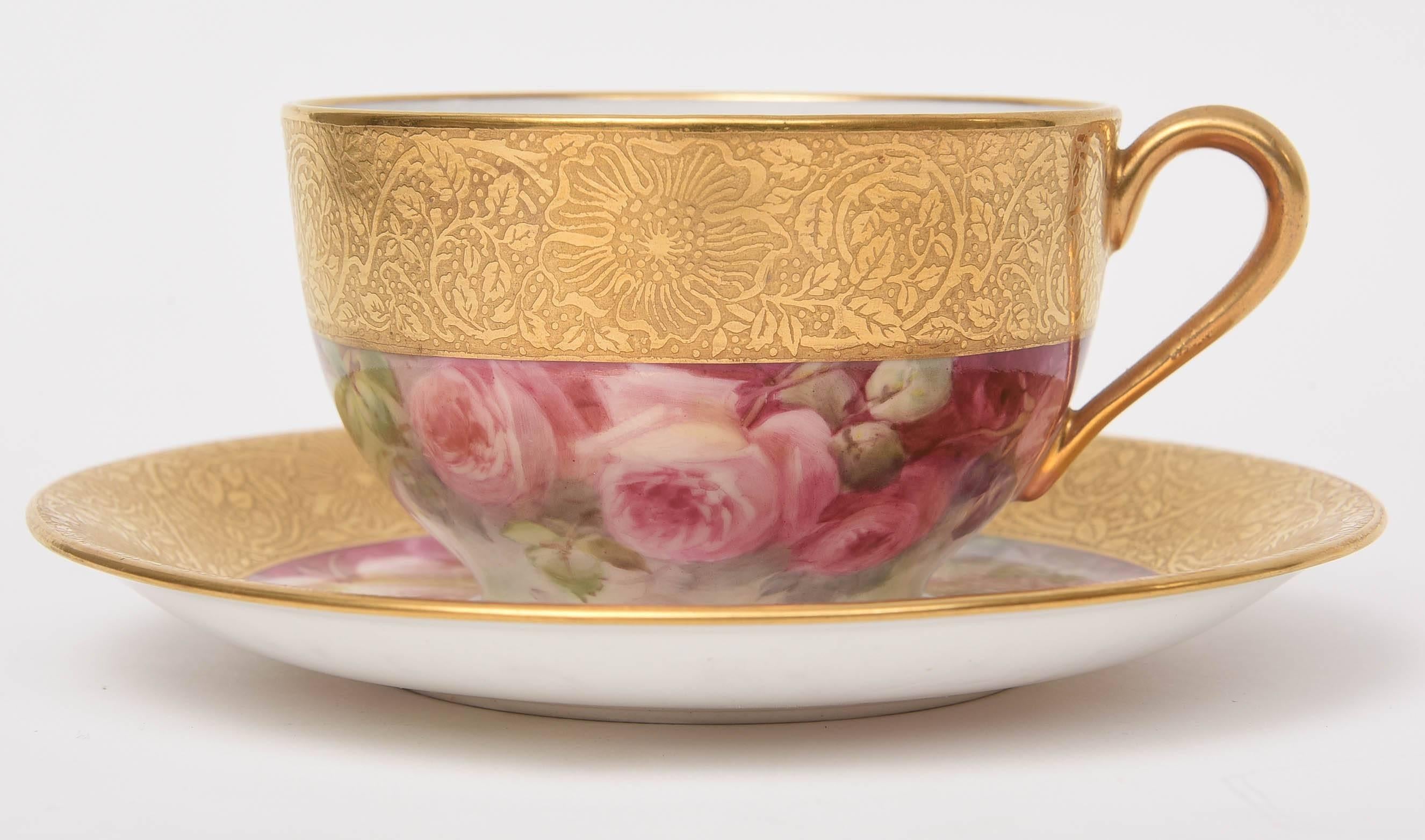 A rare and beautiful set of 12 hand-painted porcelain cup and saucers from Lenox. Masterfully painted by their re known artist: William Morley. A thick acid etched 24-karat gold band surrounds the top of the cup and saucer collar. The roses are
