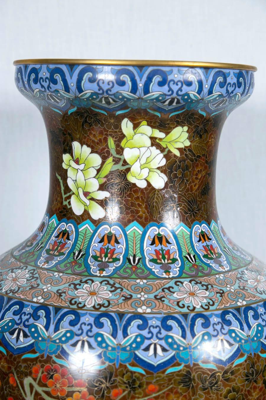 Fully decorated on a gold/brown ground, with flowers, flower pots and Chinese motifs. Brass banded tops and bases.