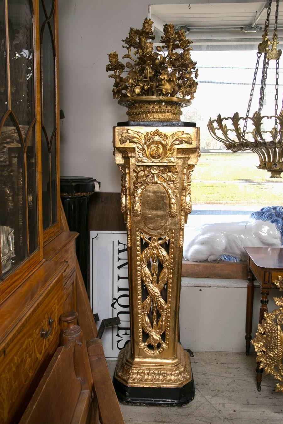This pair we believe came from the Plaza Hotel in New York City, but we have no documentation to that account.
They have been regilded.
The base is carved wood. The top flower basket is of gilt metal, holding 12 lights each.
Please note the