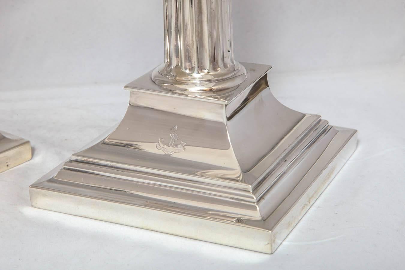 Large, beautiful pair of sterling silver, neoclassical, Corinthian column candlesticks, Tiffany & Company, New York, year marked for 1912-1913. There is an armorial on the base of each candlestick as well as a Latin motto, the translation of which