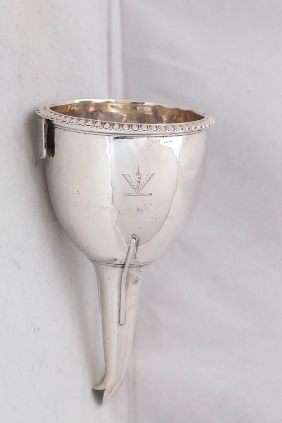 Georgian, sterling silver wine funnel, London, 1813, William Bateman - maker. Has an armorial on one side - a pheon, erect, point downward (representation of the head of a javelin, dart or arrow point, downward, with two long barbs engrailed on the