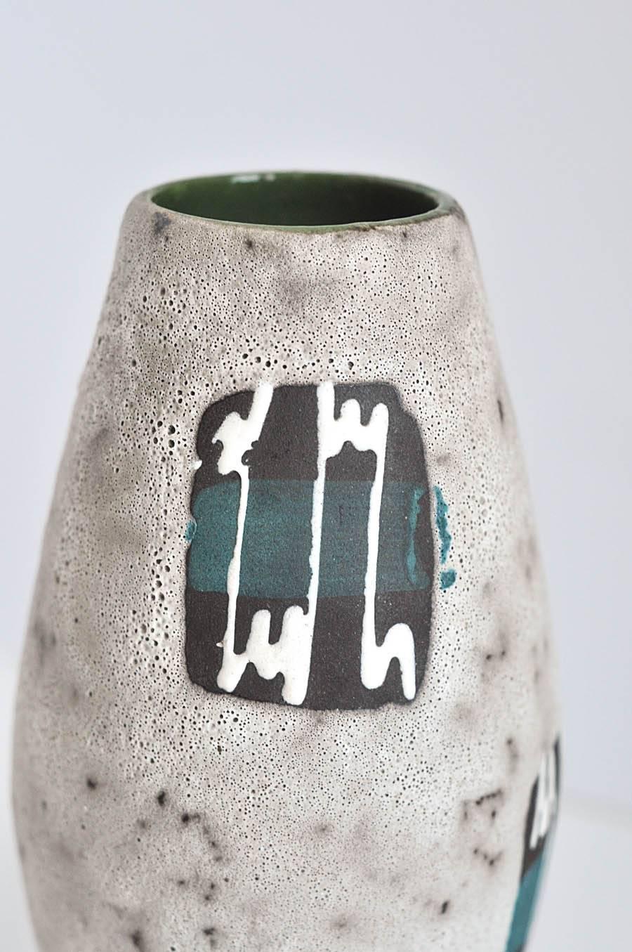 A bold vase with a complicated abstract design and glaze, by one of the leading German ceramic factories of the period, Scheurich Keramik. The decorated panels resemble electrocardiograms perhaps monitoring the 