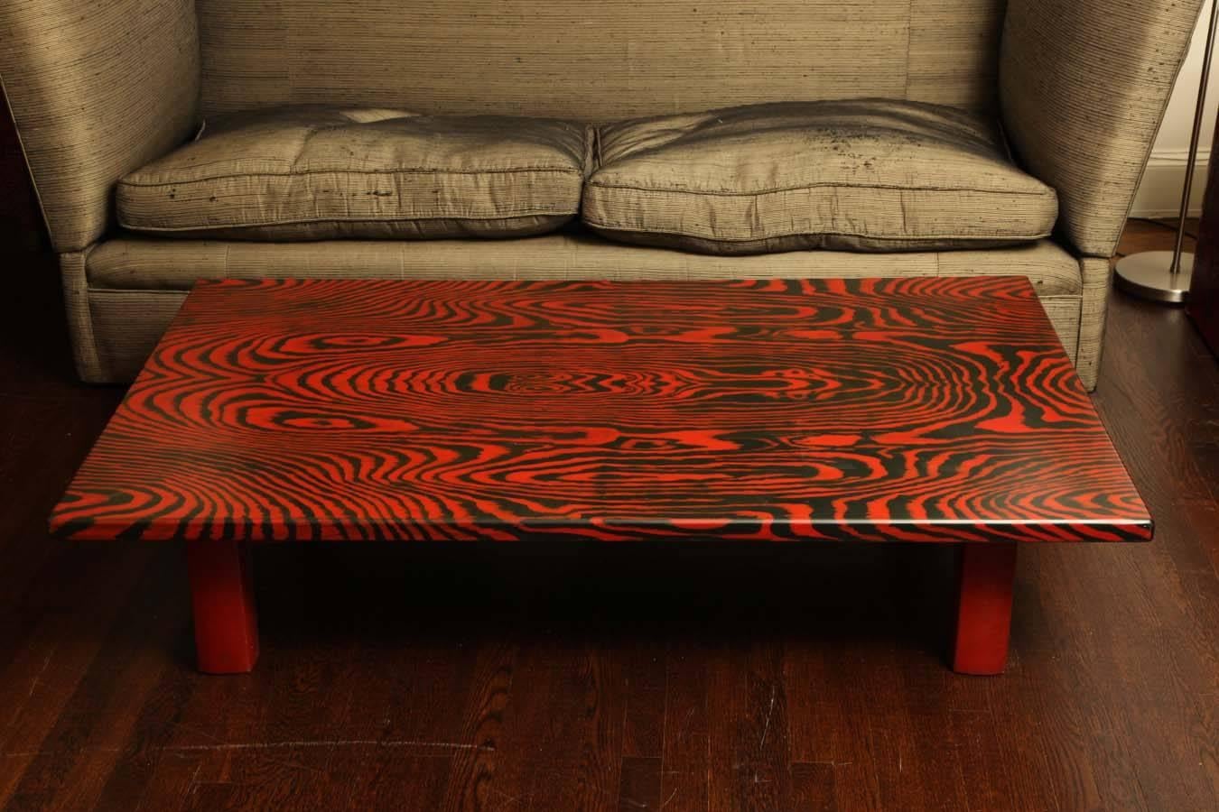 Stunning table executed in Japanese lacquer; the rectangular top raised on square straight legs.
