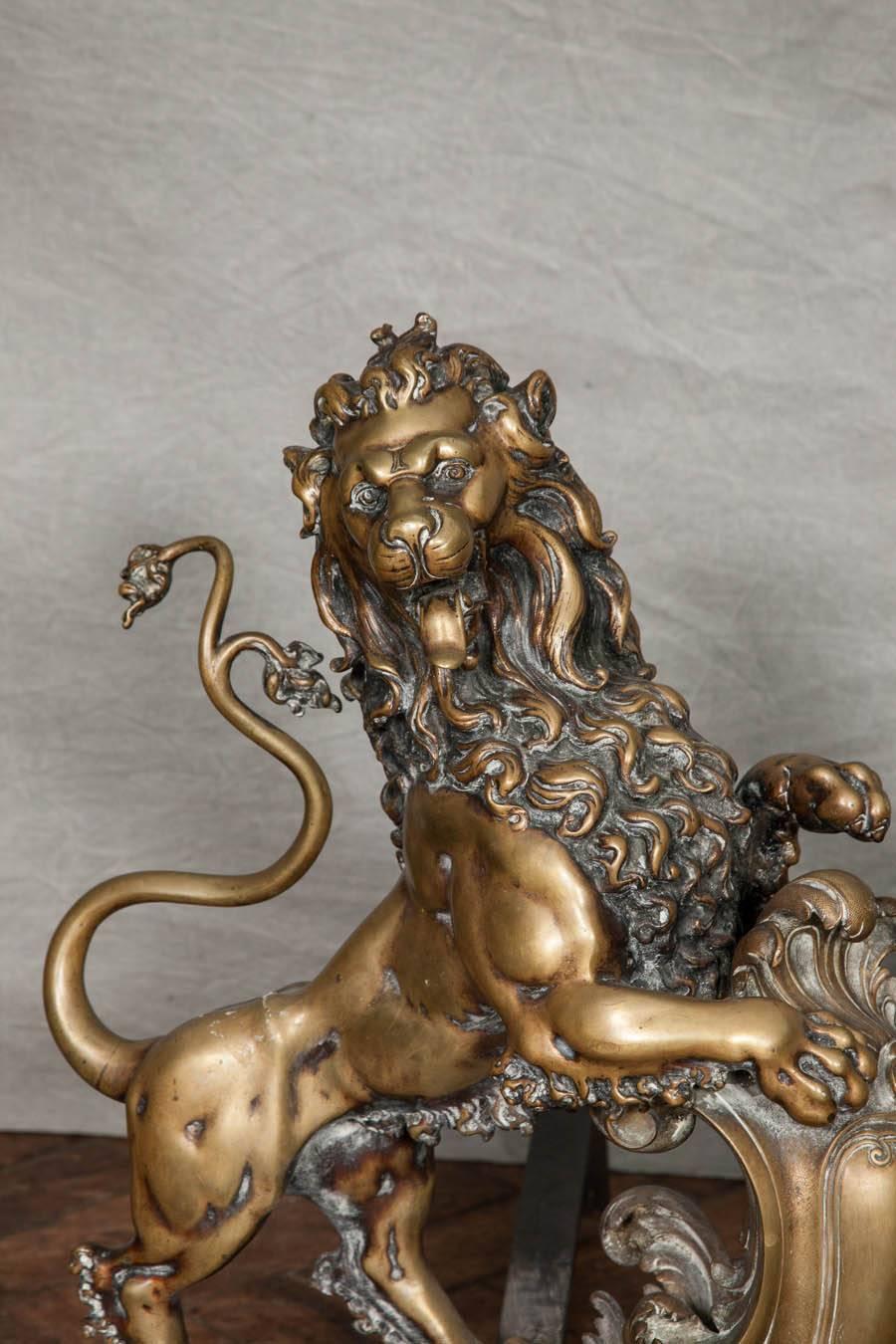 A very impressive pair of 19th century bronze chenets, depicting rampant lions resting on Rococo style scrolling shields.