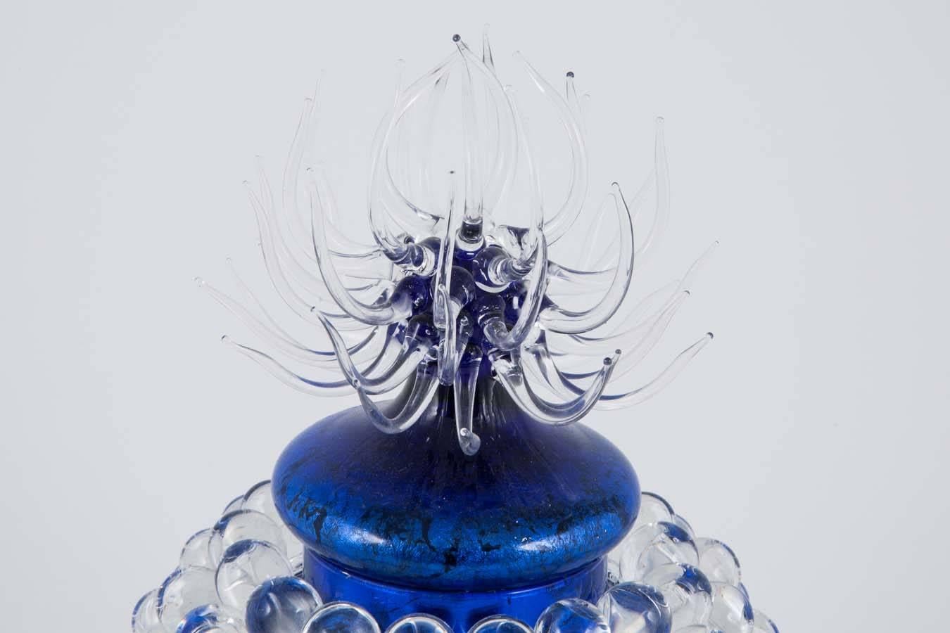 A unique art glass jar by the British glass artist James Lethbridge. Blown glass with gilding on the inside. The outer layer is covered in flameworked decoration and adornment.

Initially following a career choice in production ceramics and gaining