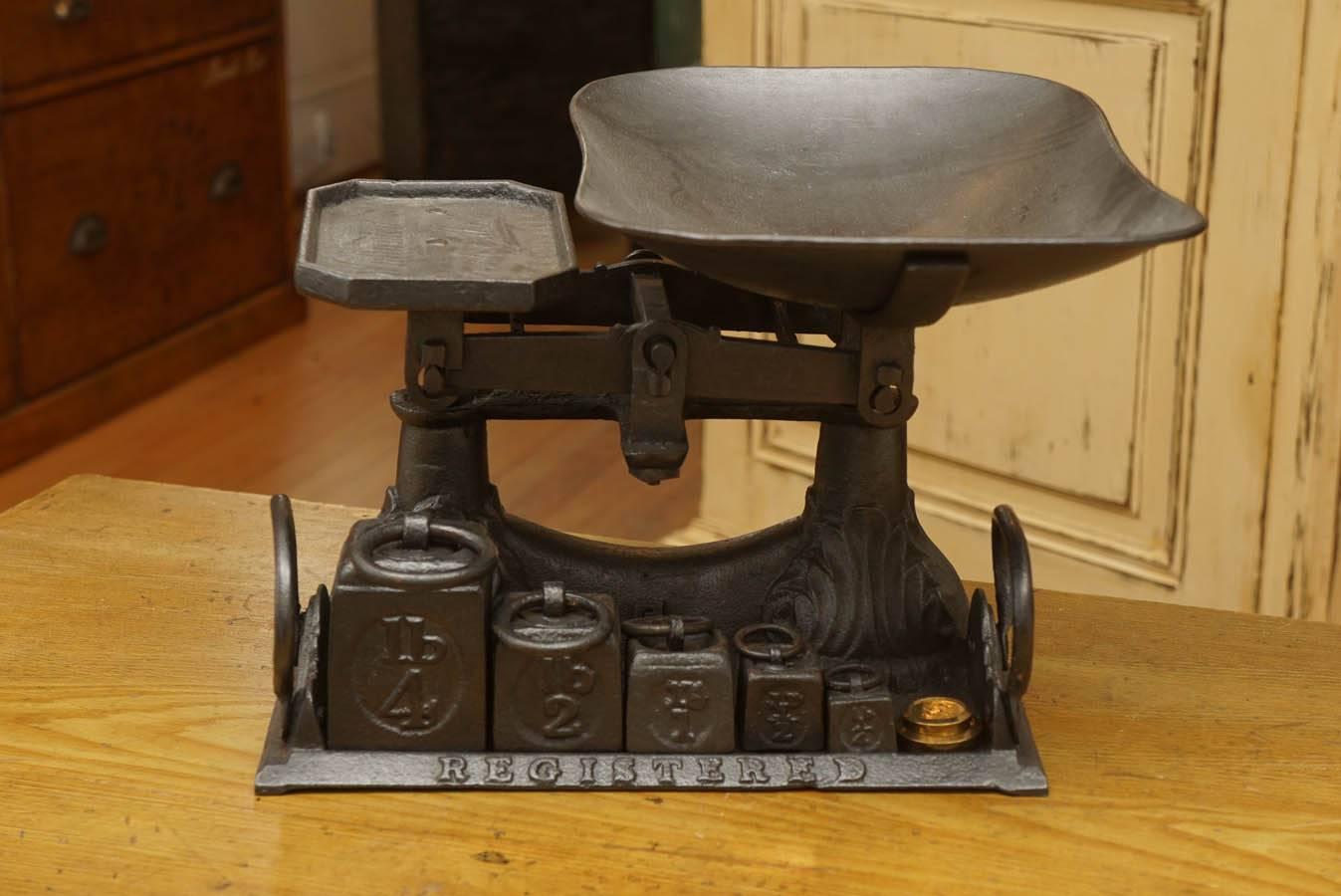 This scale is part of a very large collection of ever changing scales at painted porch. We love scales as a decorative item and this one is a beauty. Complete with original weights starting at 4 pounds. The tray is a beauty as well.