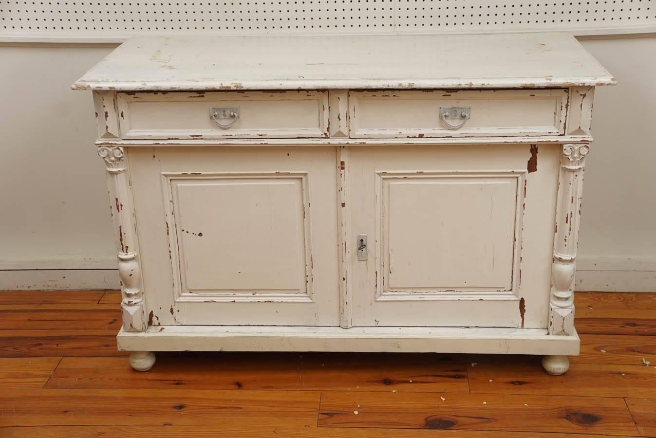 The French do wonders with their moulding and this soft, romantic buffet is no exception. With original hardware and lock this worn off-white buffet is most functional as well as a pretty look. One inside shelf with no vertical separation makes for